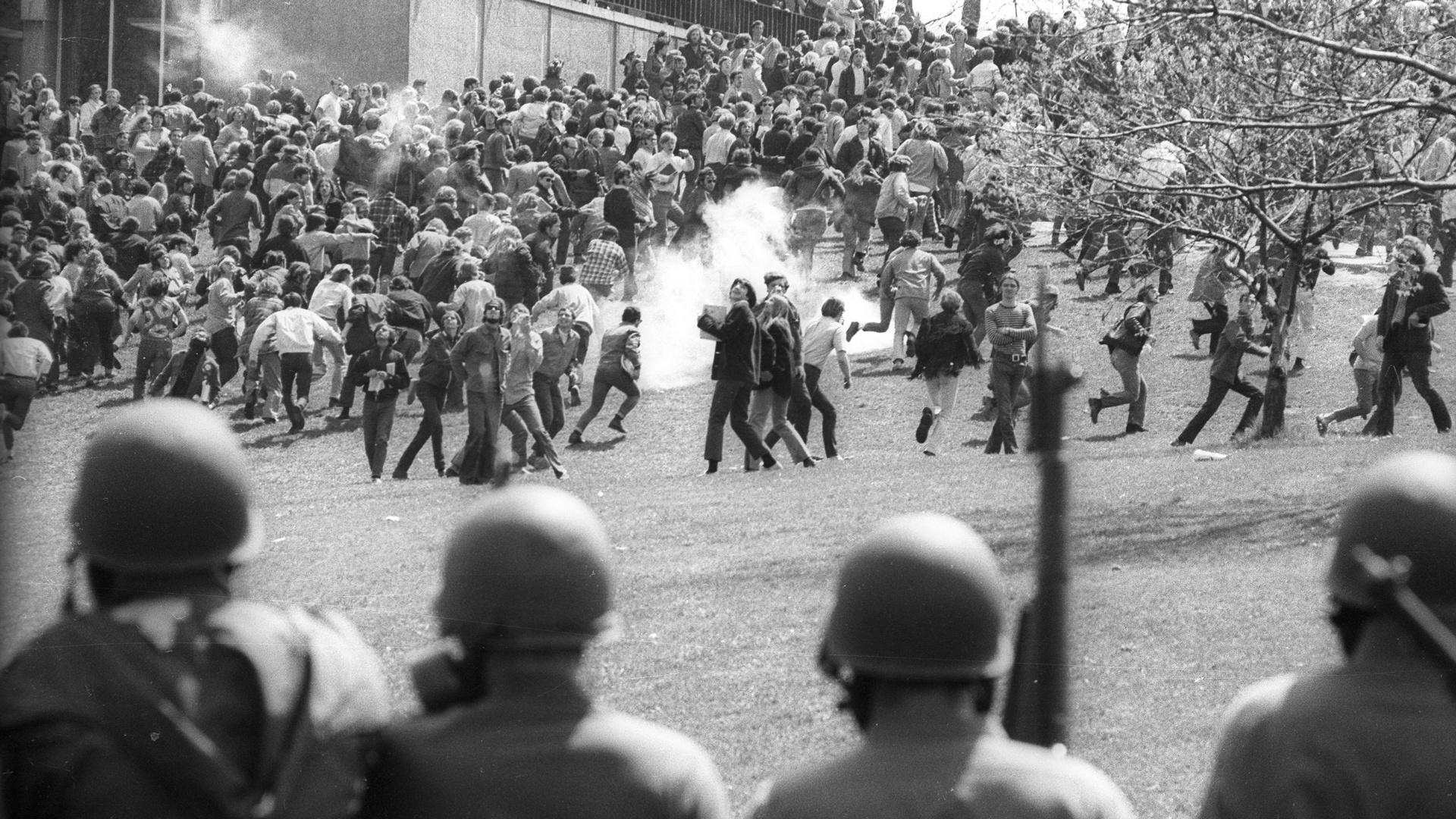 May 4, 1970, students retreat up Blanket Hill as guards advance with tear gas at Kent State.