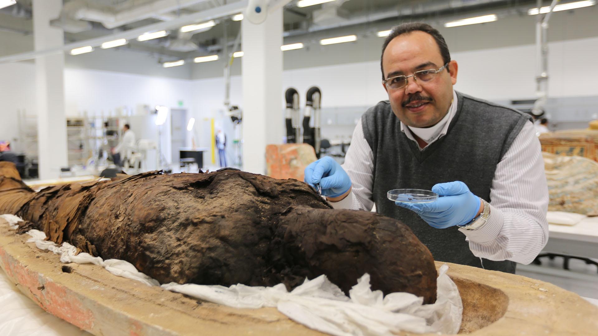 Dr. Medhat Abdallah at the GEM working on the conservation of a sarcophagus.