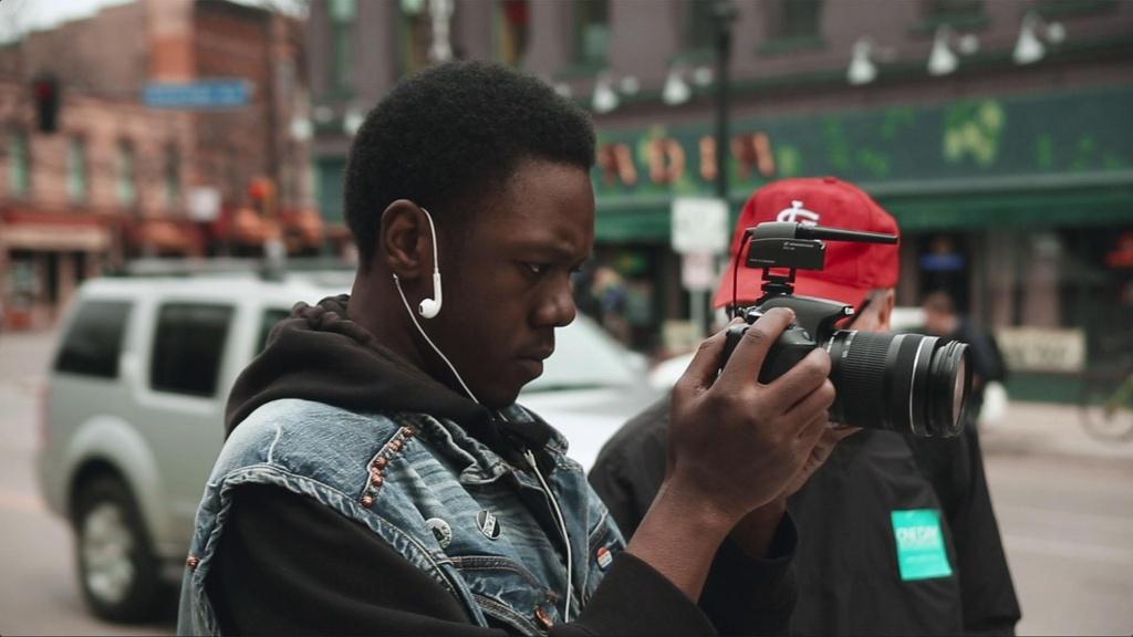 Closeup image of filmmaker holding camera