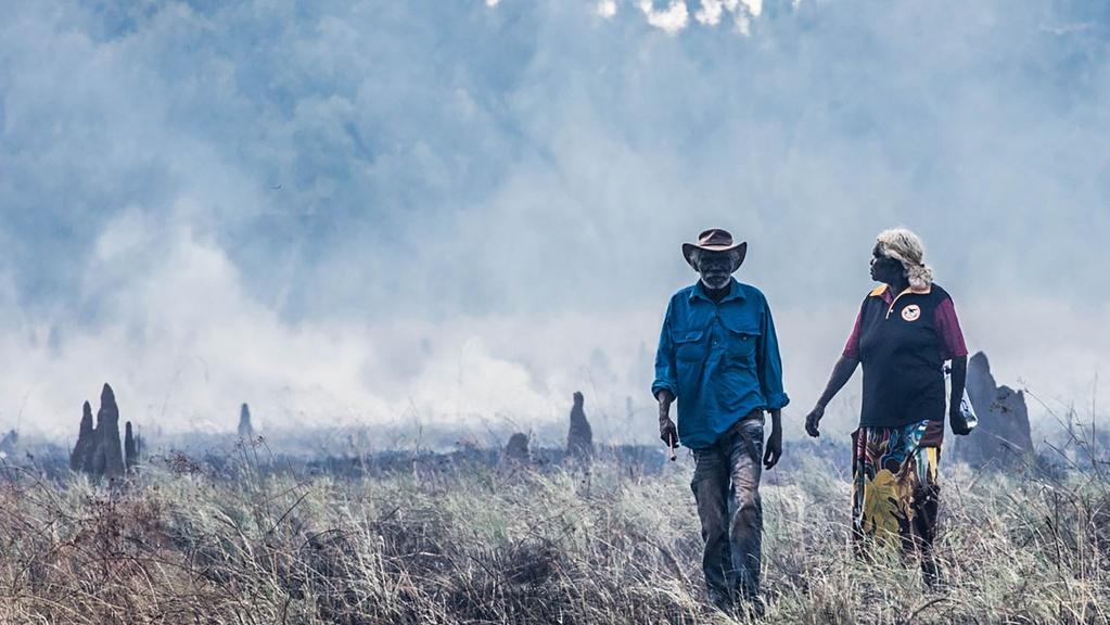 Image of male and woman standing in field.
