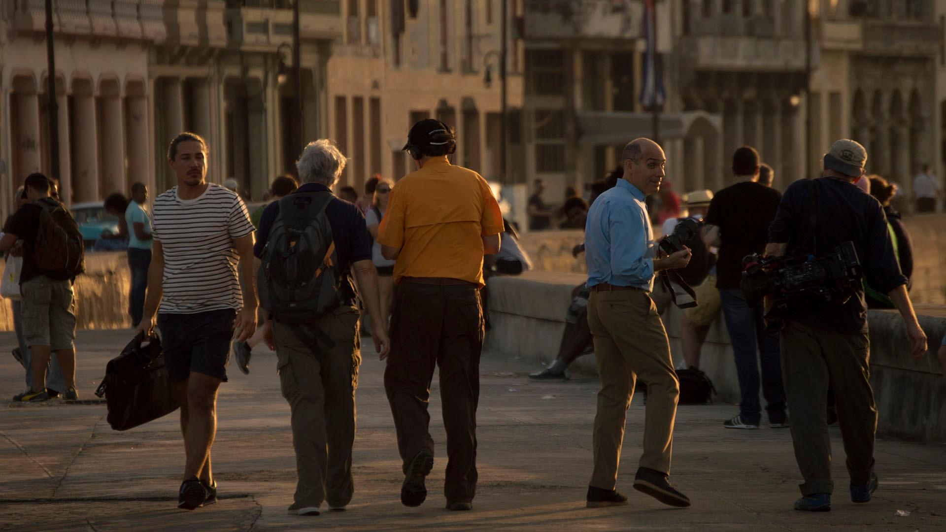 Geoffrey Baer and production crew walking along the Malecon.