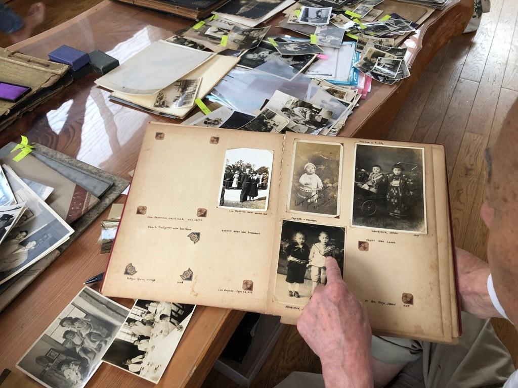 George Uno at home in Japan, looking through archives (Buddy Uno story)