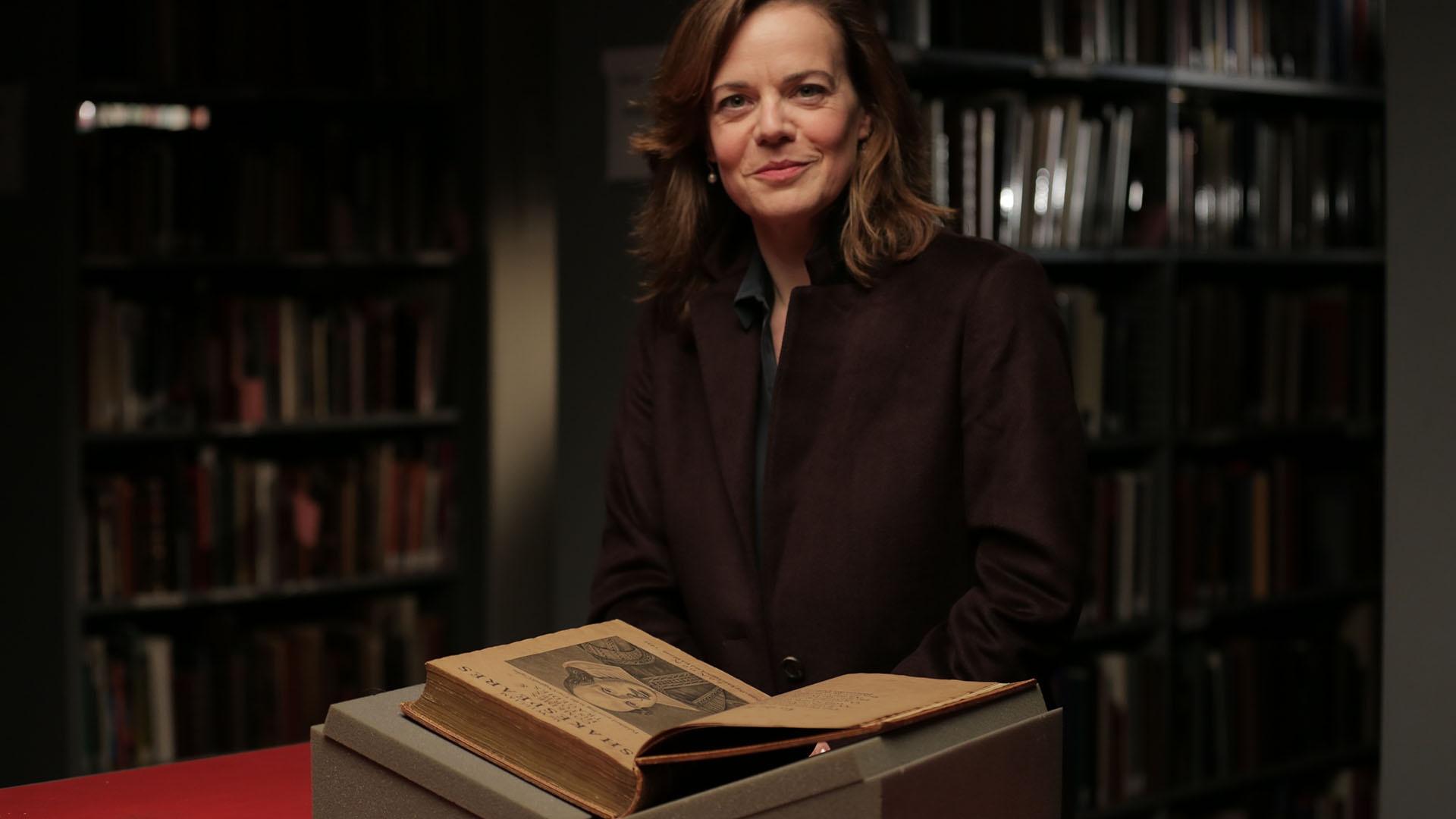 Host Helen Castor looking through Shakespeare’s First Folio.