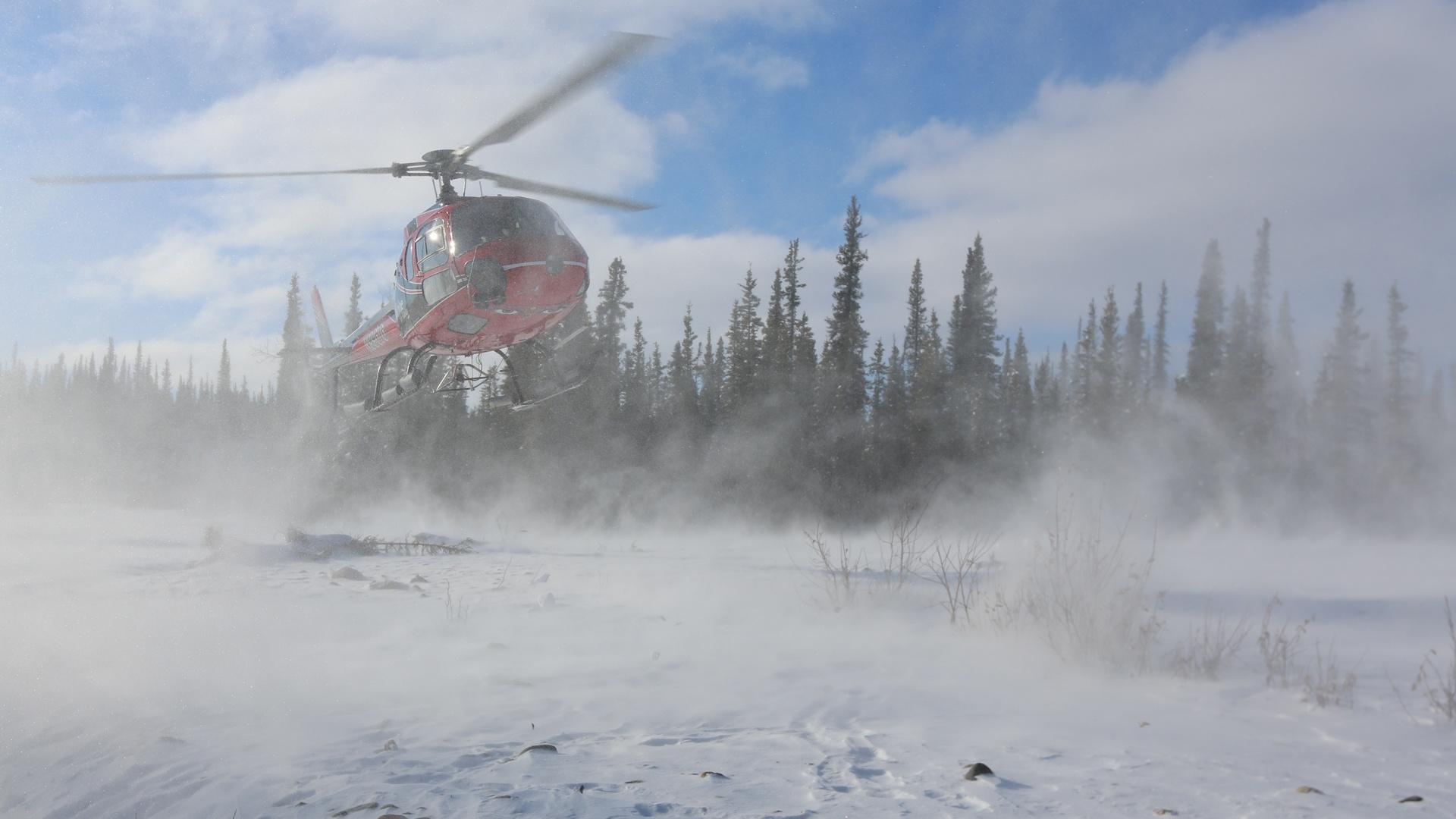 Image of helicopter landing in snow.