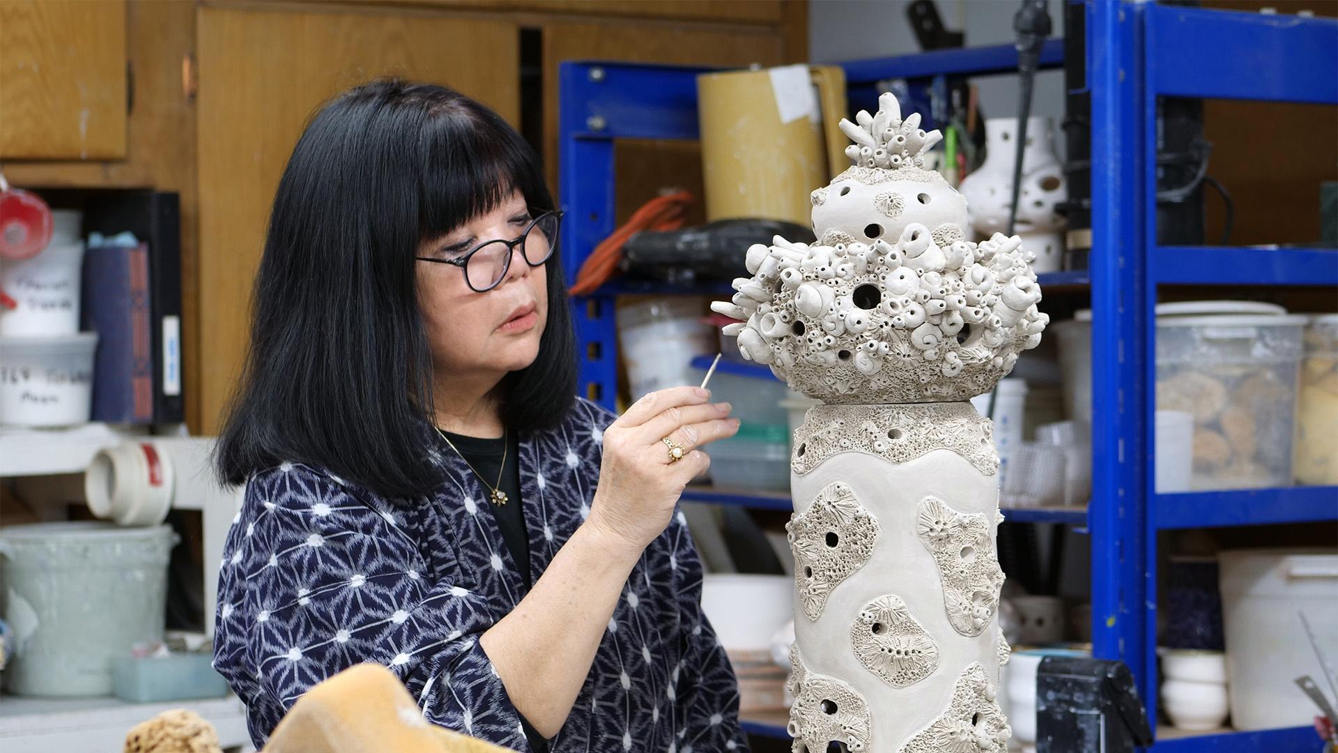 Ceramic artist Joan Takayama-Ogawa works on her coral pieces