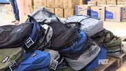 Volunteers Stuff Backpacks with School Supplies