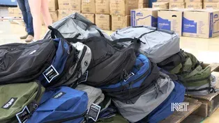 Volunteers Stuff Backpacks with School Supplies
