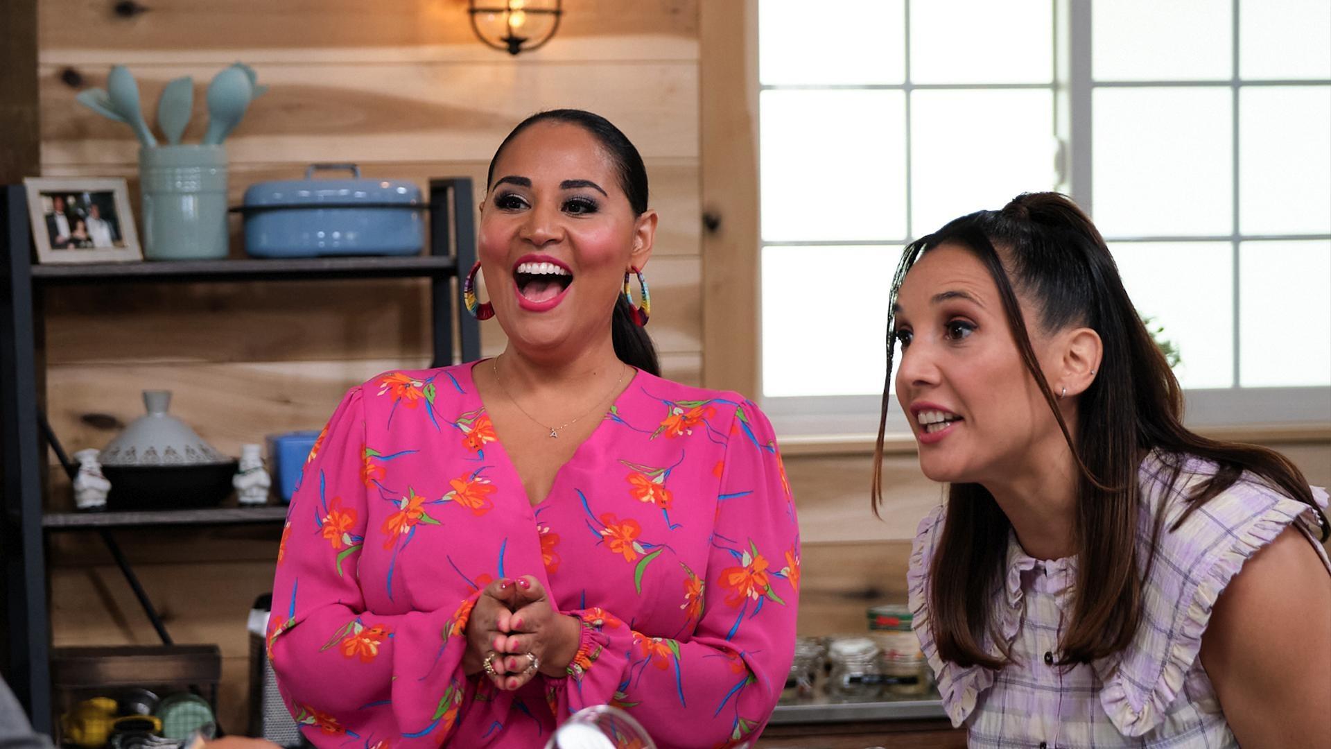 two girls smiling and laughing in a kitchen