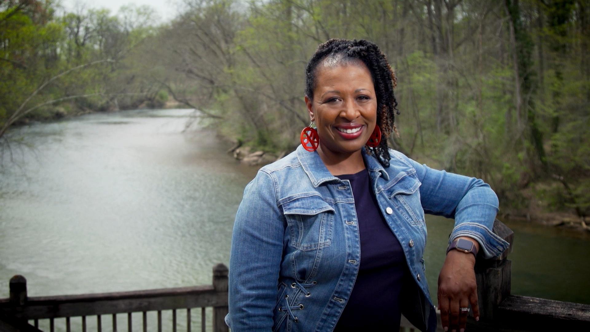 Deborah Holt Noel, host of NC Weekend, smiling with a river behind her.
