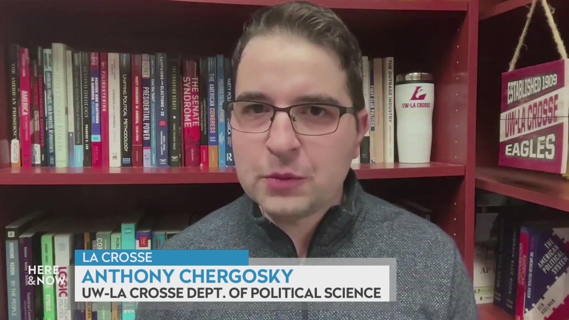 A still image shows Anthony Chergosky seated in front of brown bookshelves lined with books with a graphic at bottom reading 'La Crosse,' 'Anthony Chergosky' and 'UW-La Crosse Dept. of Political Science.'
