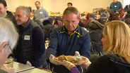 Politicians and volunteers serve up hot meals