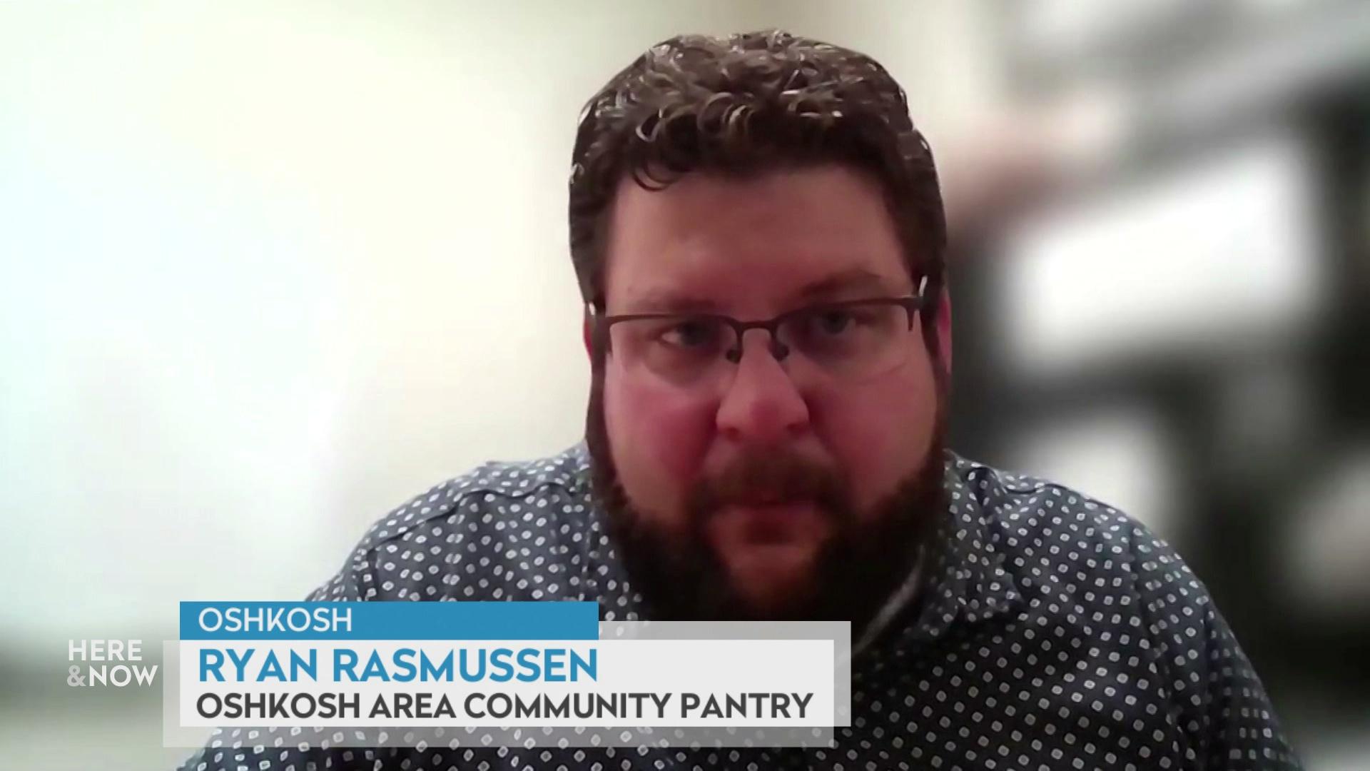 A still image from a video shows Ryan Rasmussen seated in front of a blurred background with a graphic at bottom reading 'Oshkosh,' 'Ryan Rasmussen' and 'Oshkosh Area Community Pantry.'