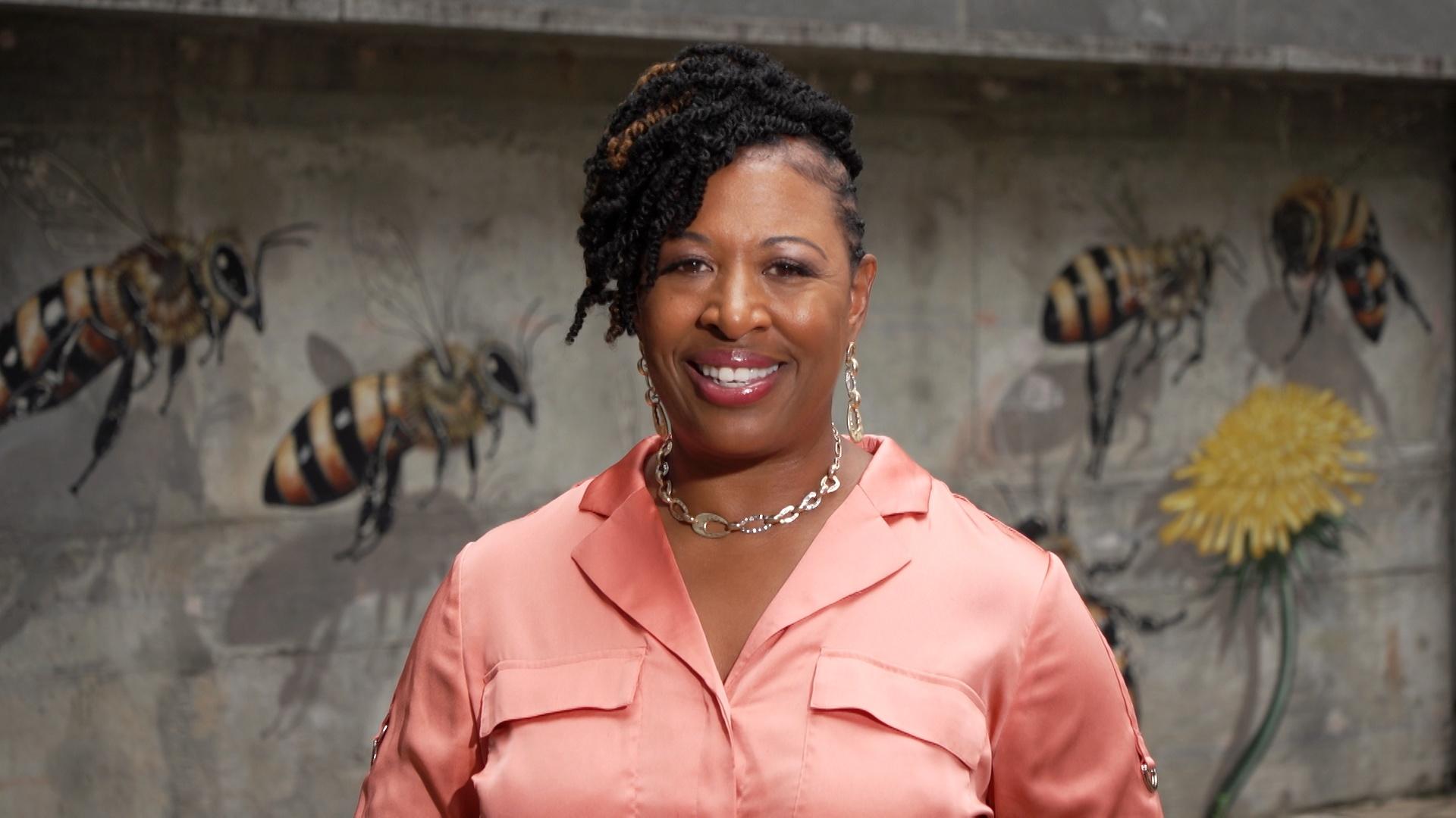 Deborah Holt Noel in front of a mural.