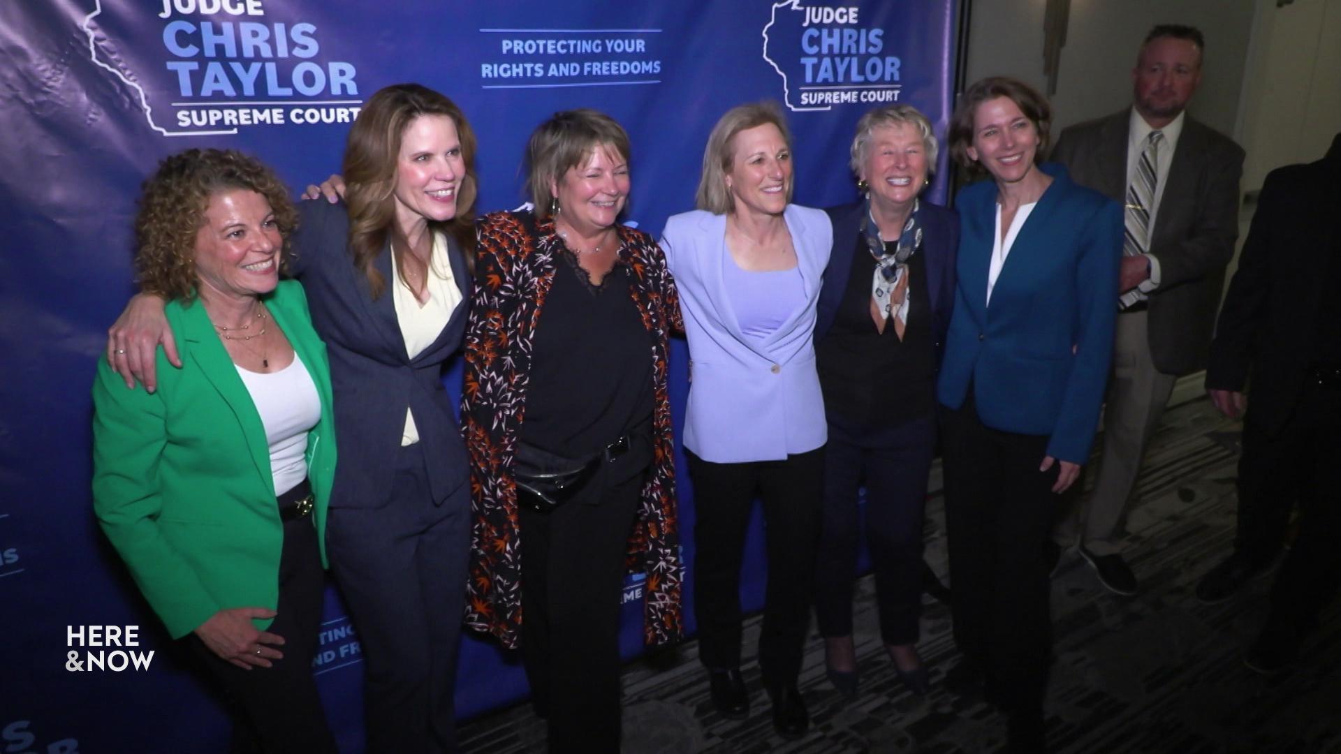 A still image shows former, future and current justices posing at Chris Taylor's election victory, from left to right Rebecca Dallet, Chris Taylor, Janet Protasiewicz, Jill Karofsky, Ann Walsh Bradley and Susan Crawford.
