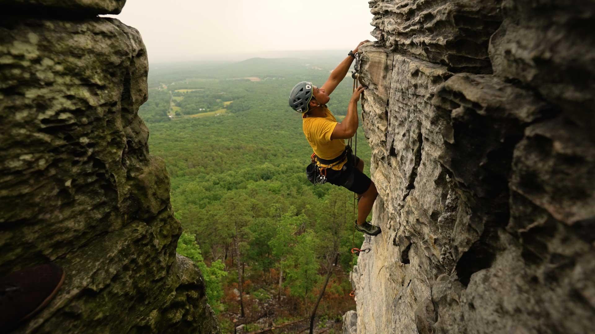 A man rock climbing at Pilot Mountain State Park
