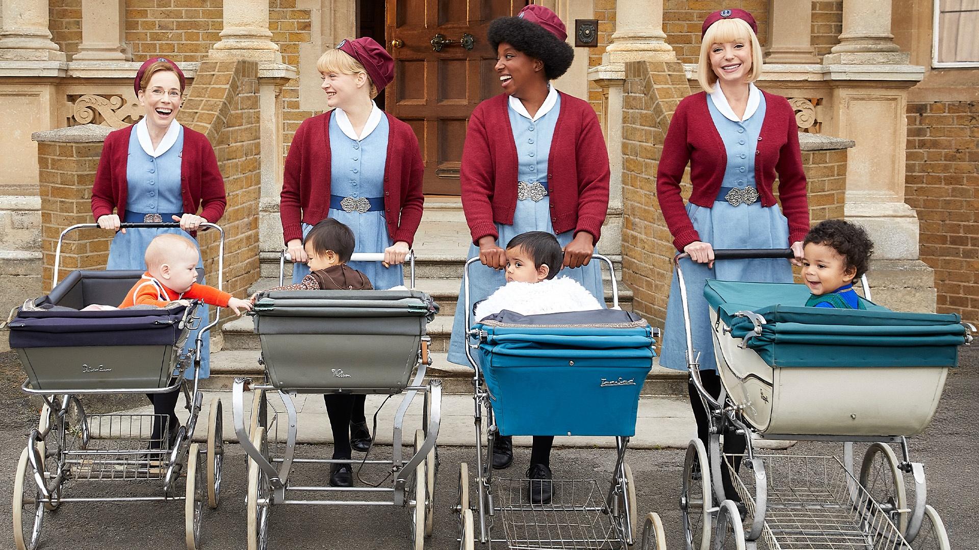 The cast of Call the Midwife pushing babies in prams from the 70s.