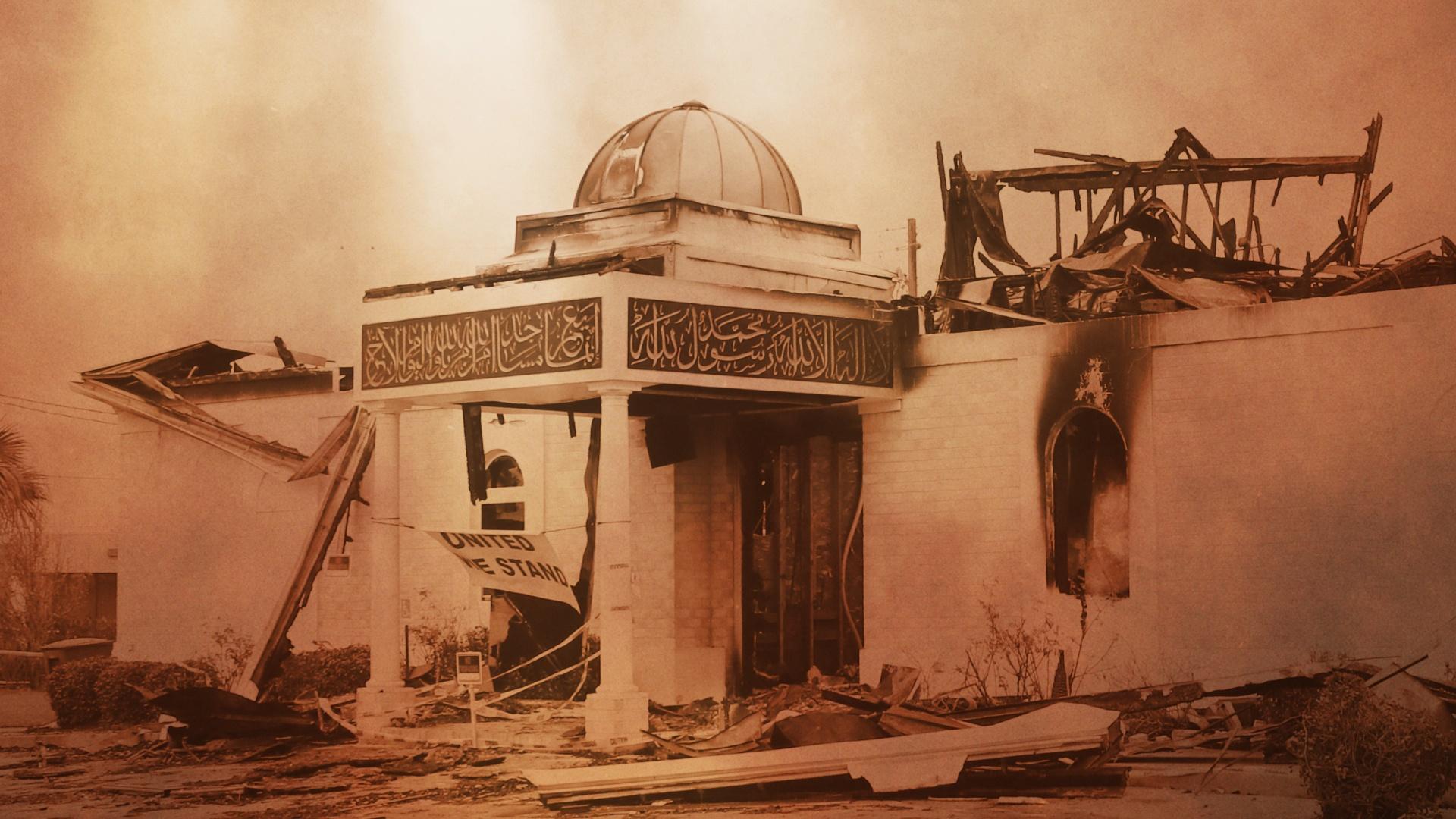 A sepia toned image of a burned down mosque.