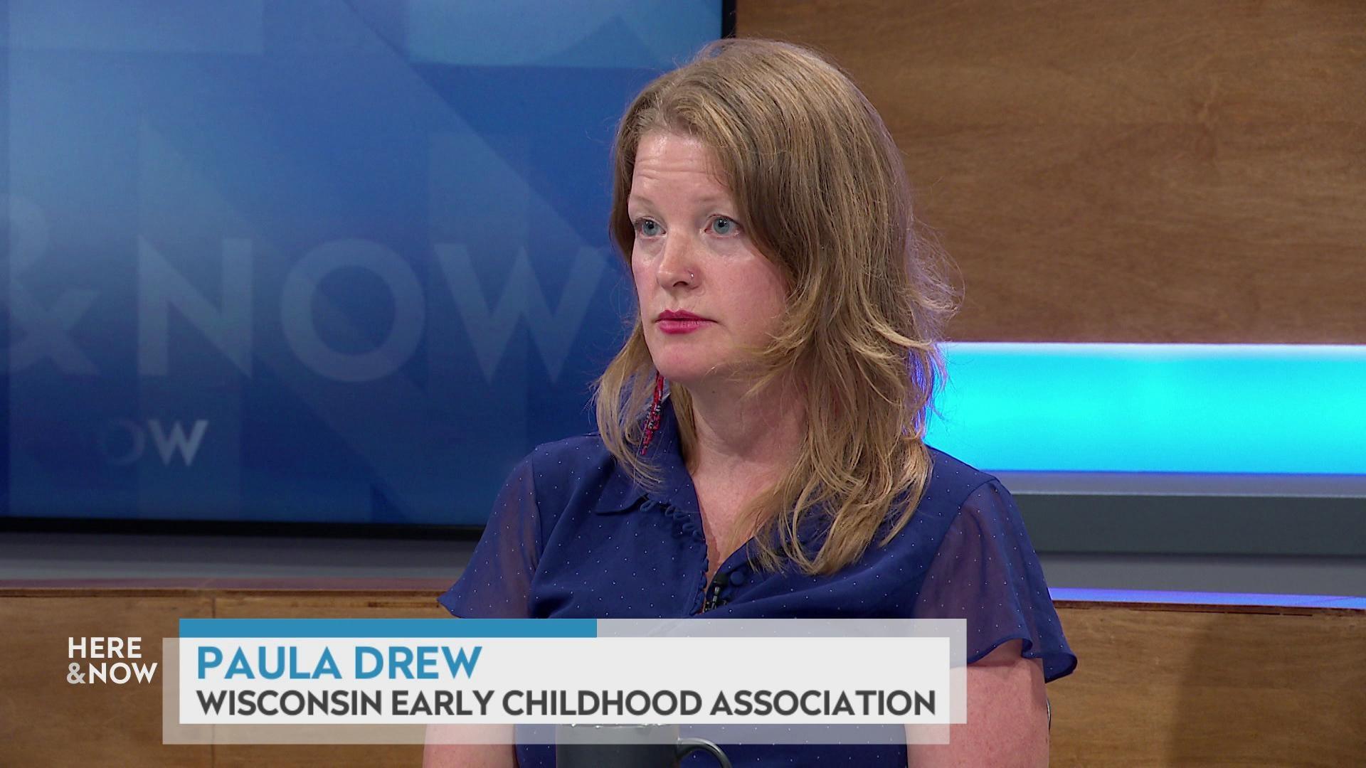 A still image shows Paula Drew seated at the 'Here & Now' set featuring wood paneling, with a graphic at bottom reading 'Paula Drew' and 'Wisconsin Early Childhood Association.'