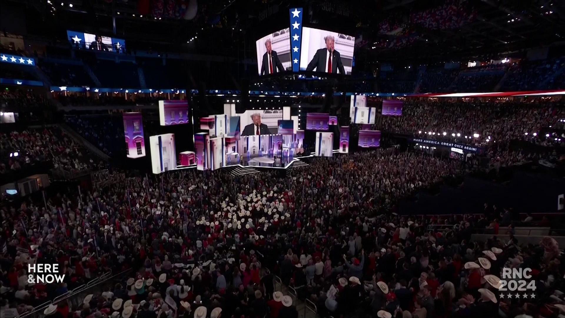 Multiple screens depict Donald Trump standing on a stage and speaking into a microphone.