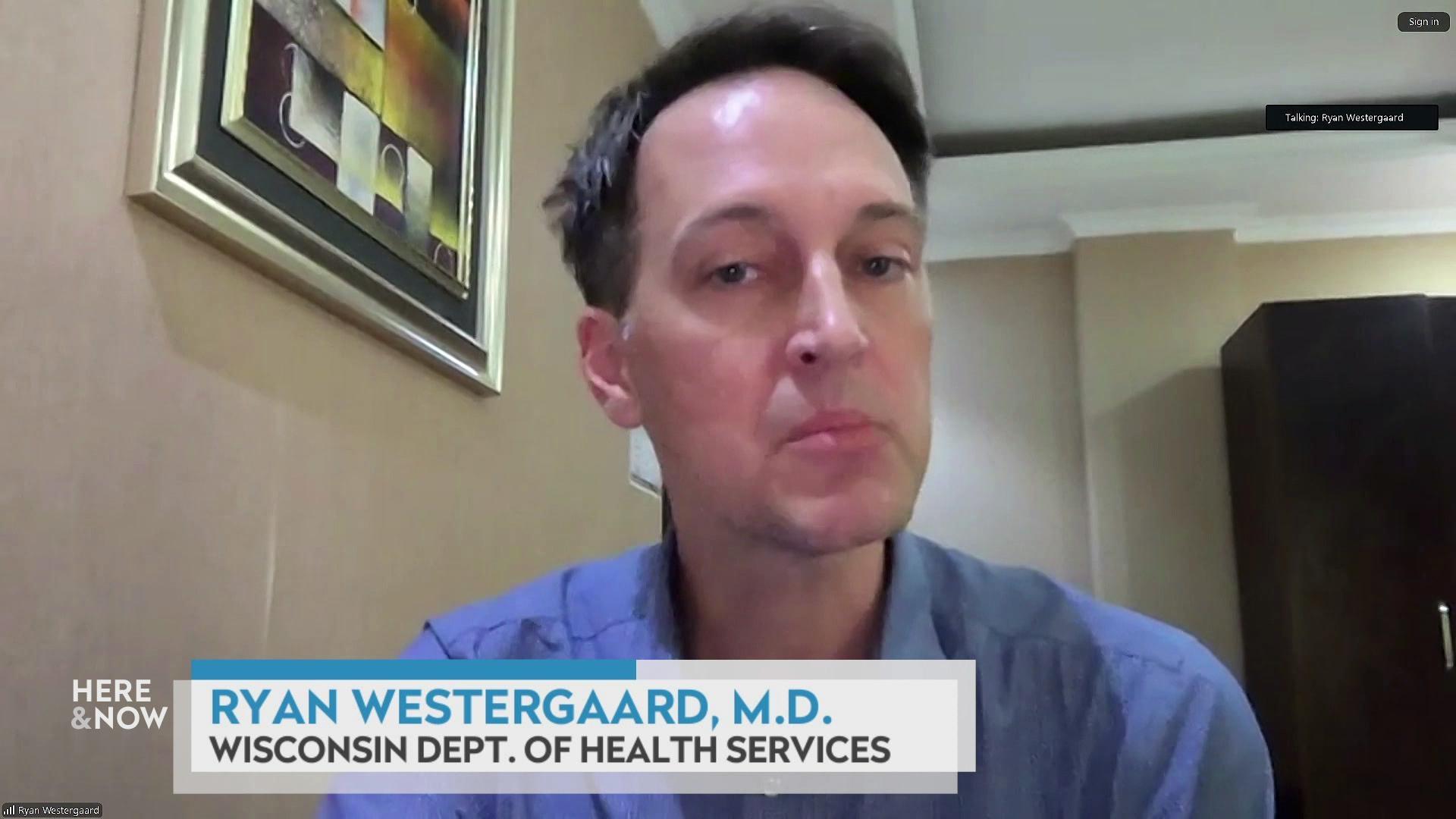 A still image shows Dr. Ryan Westergaard seated in front of an abstract painting, with a graphic at the bottom that reads 'Ryan Westergaard, M.D.' and 'Wisconsin Dept. of Health Services.'