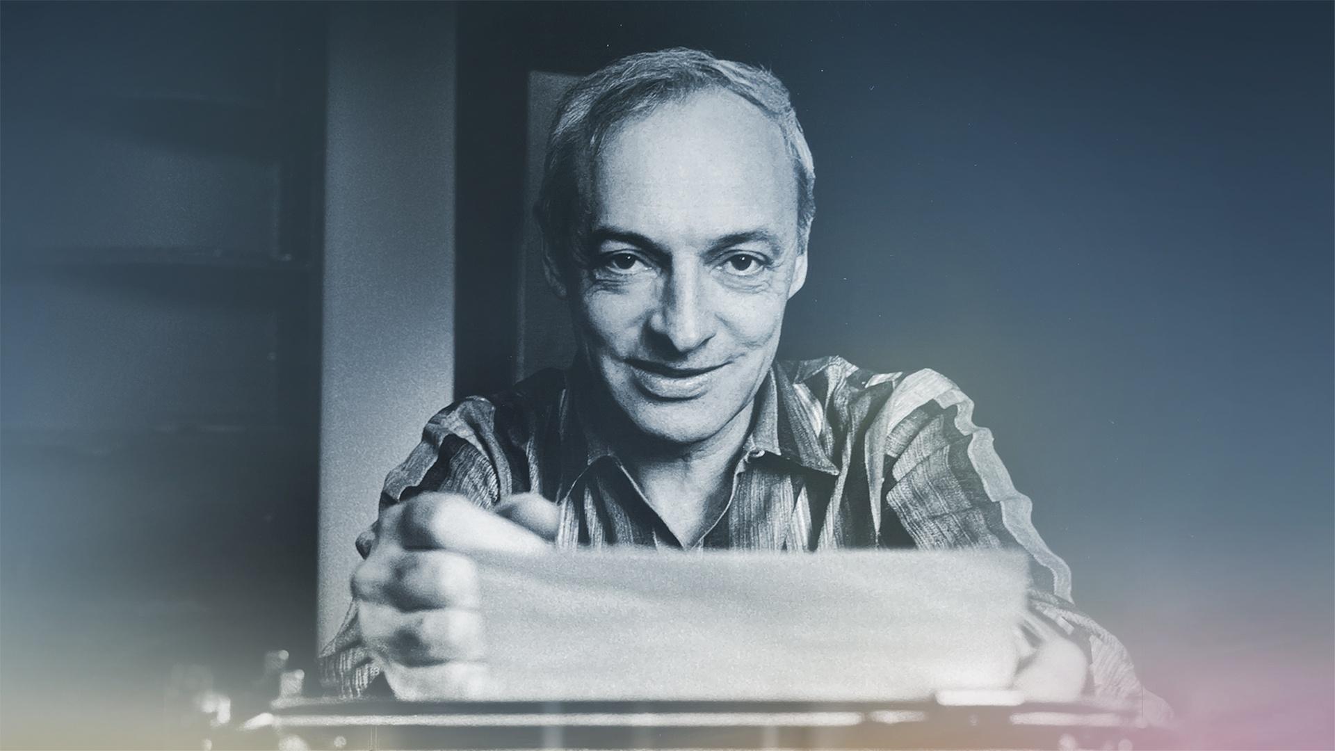 a portrait of saul bellow with his arms crossed in a plaid shirt