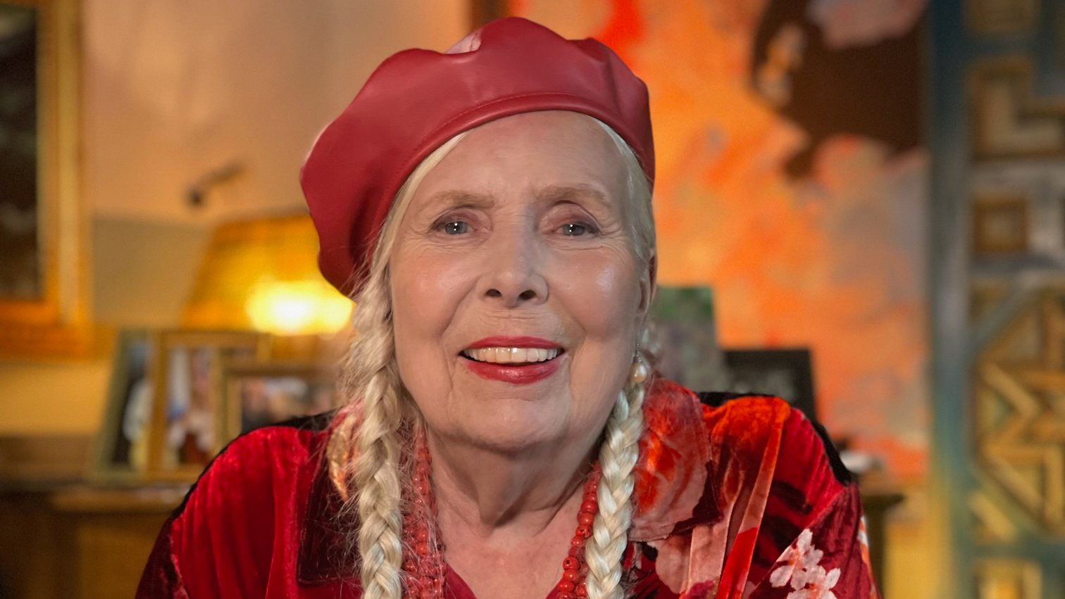 a picture of joni mitchell in a red hat and red shirt