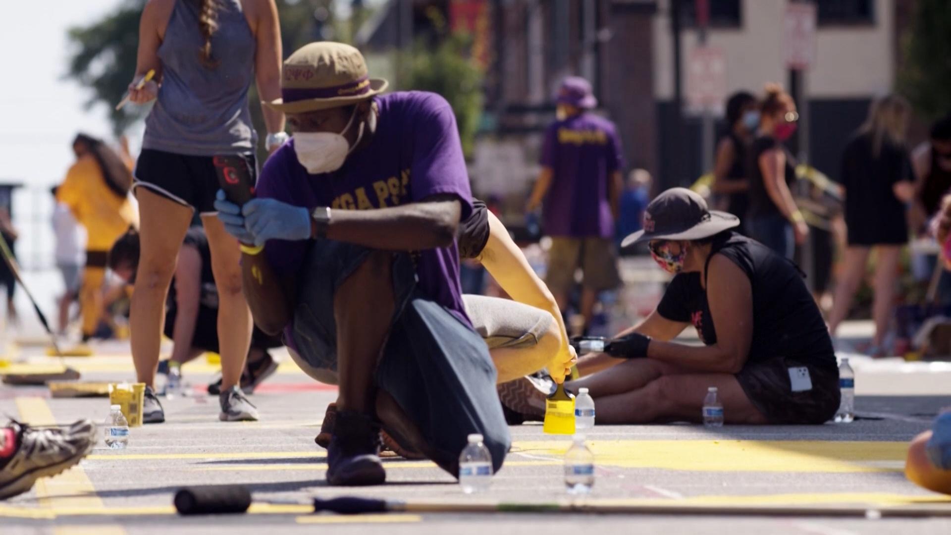 Black community members - two men and two women- having conversation