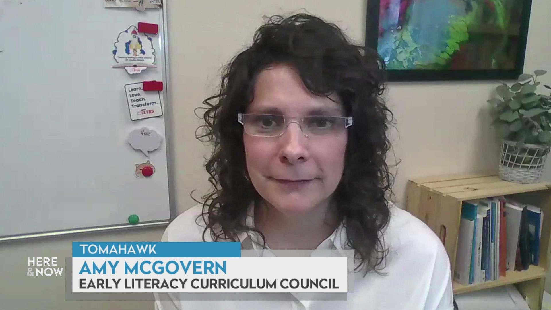 A still image from a video shows Amy McGovern seated in front of whiteboard with magnets with a graphic at bottom reading 'Tomahawk,' 'Amy McGovern' and 'Early Literacy Curriculum Council.'