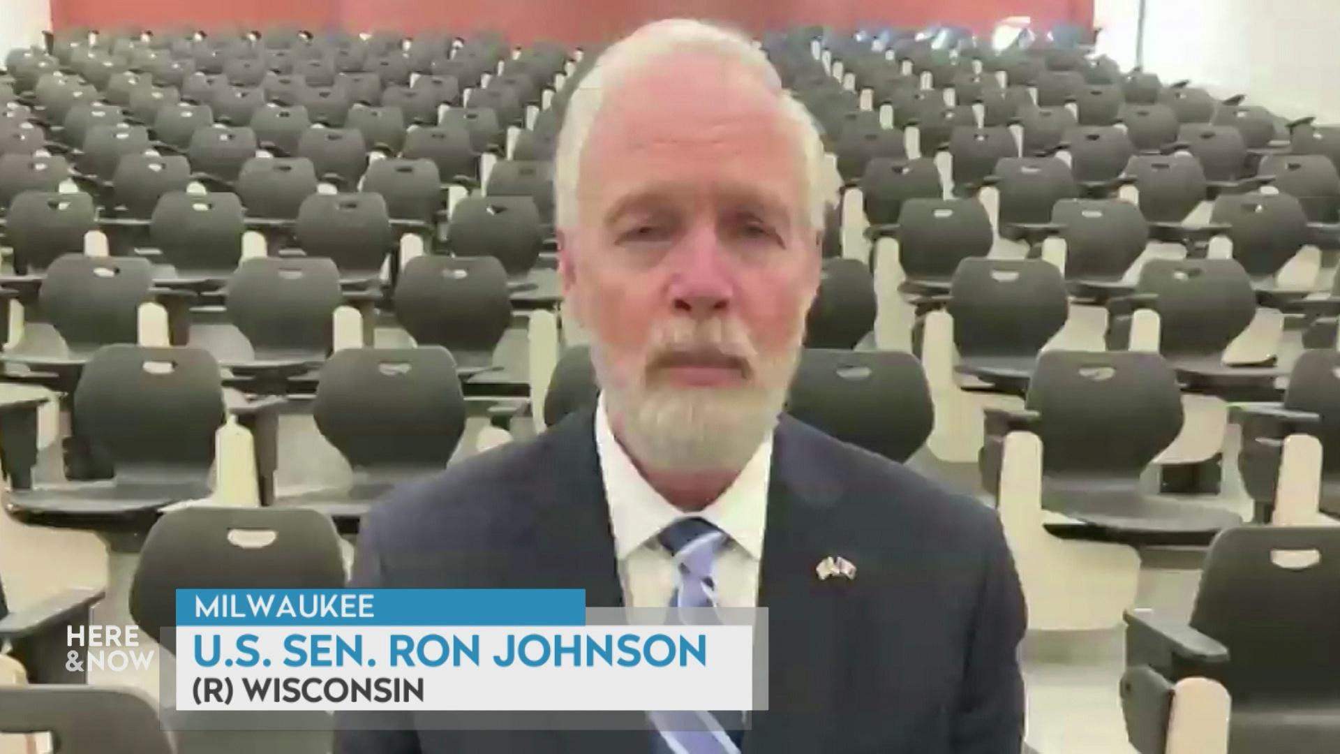 A still image shows Ron Johnson seated behind rows of empty seats in a large hall with a graphic at bottom reading 'Milwaukee,' 'Ron Johnson' and '(R) Wisconsin.'
