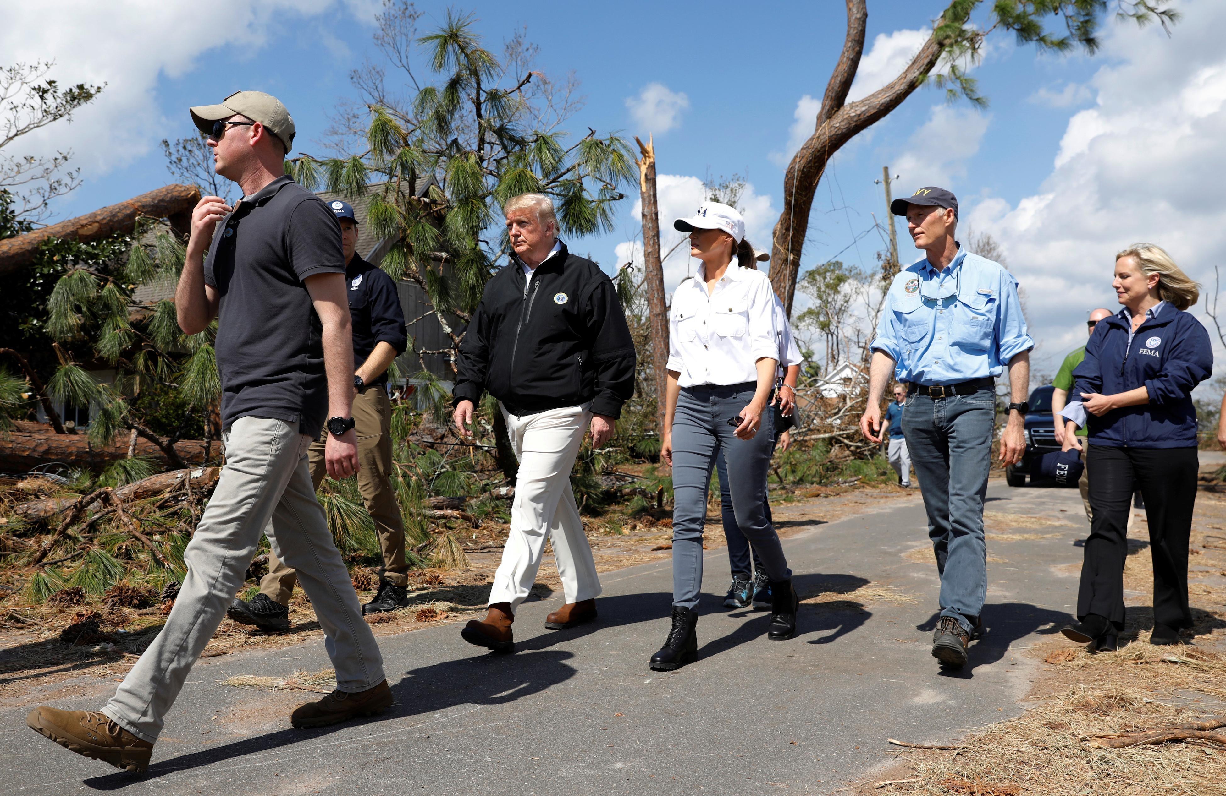 Trump tours Michael’s devastation, questions climate science