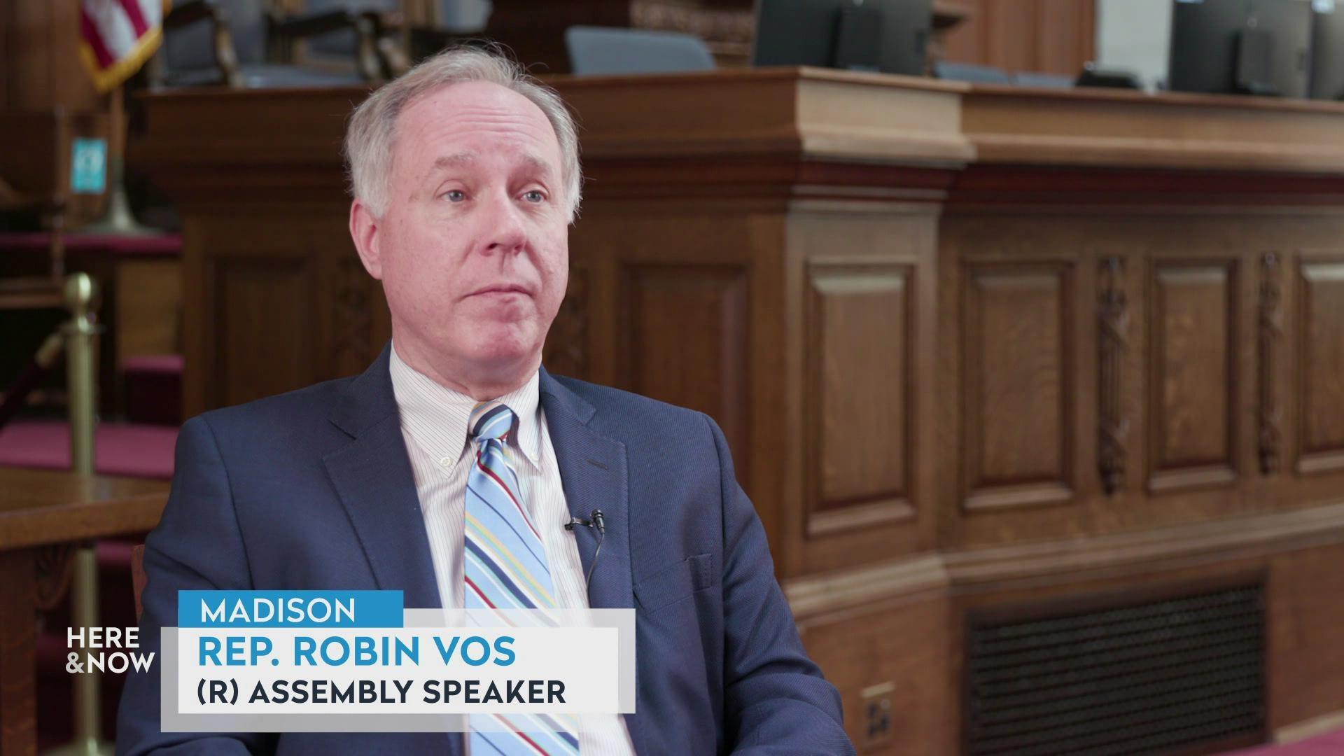 A still image shows Assembly Speaker Rep. Robin Vos seated on the assembly floor in front of an ornate wooden podium, with a graphic at the bottom reading 'Madison,' 'Repi. Robin Vos' and '(R) Assembly Speaker.'