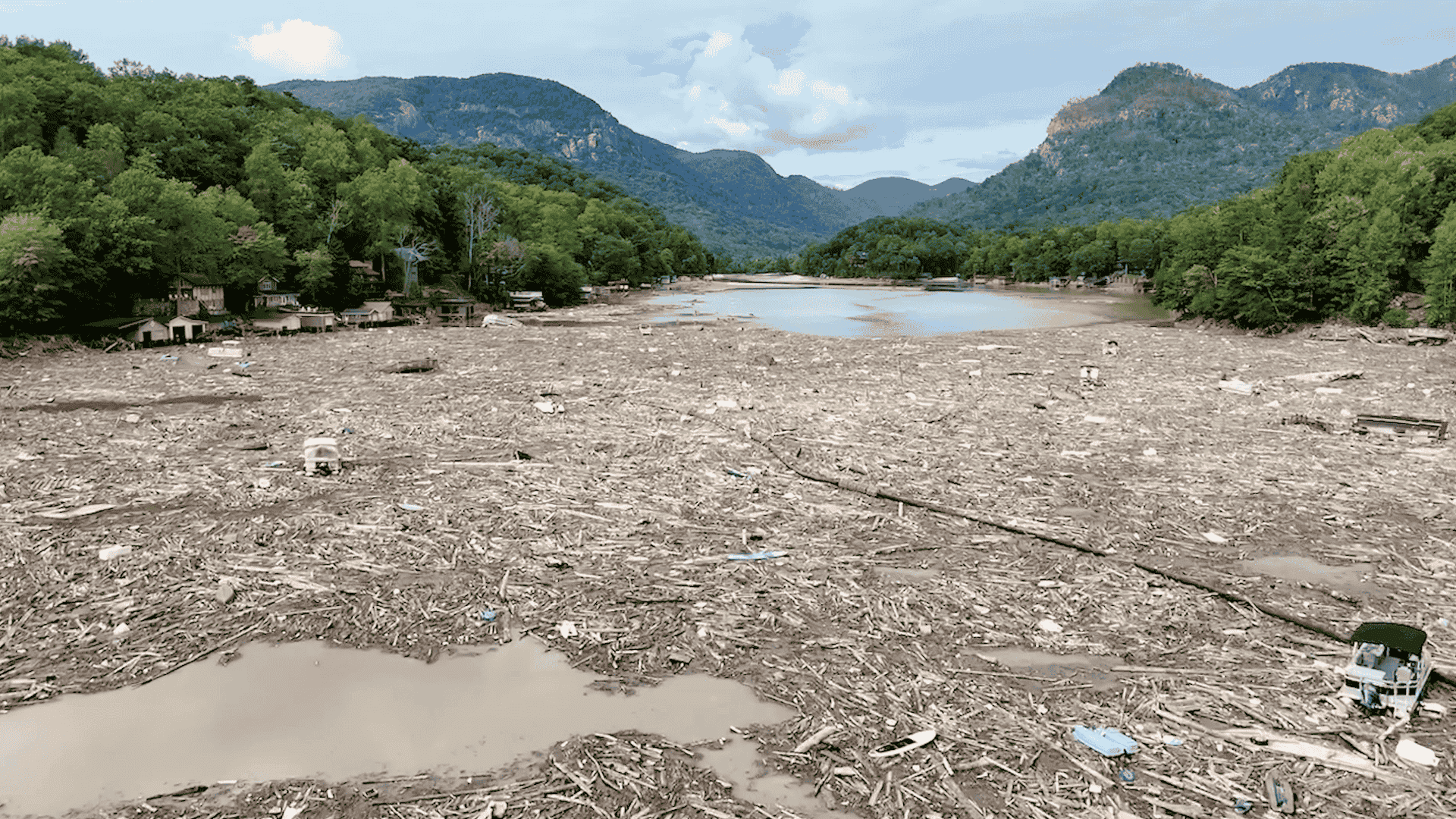 Lake Lure with a layer of debris from Hurricane Helene on the surface.