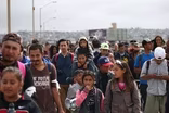 U.S. allows in trickle of asylum seekers from caravan