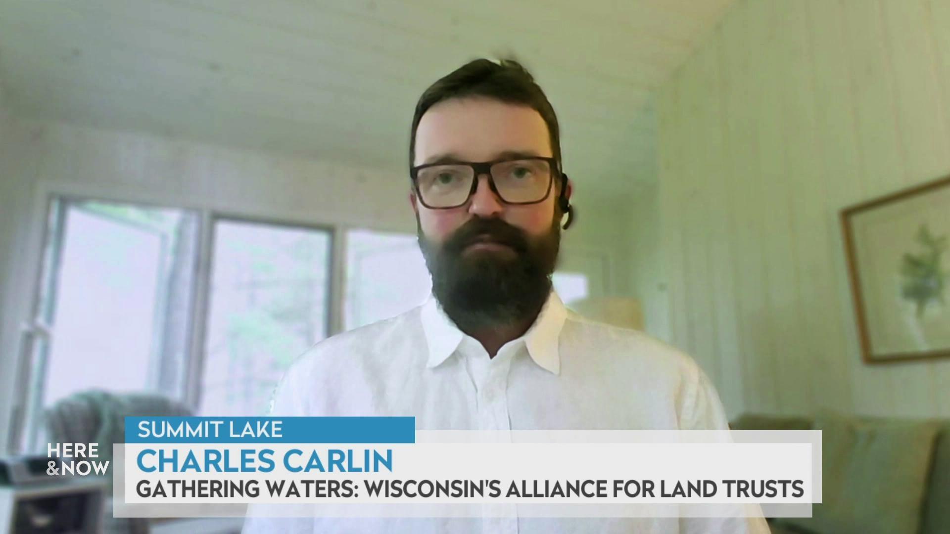 A still image shows Charles Carlin seated in front of a green couch, with a graphic at the bottom that reads 'Summit Lake,' 'Charles Carlin' and 'Gathering Waters: Wisconsin's Alliance for Land Trusts.' A still image shows Charles Carlin seated in front of a green couch, with a graphic at the bottom that reads 'Summit Lake,' 'Charles Carlin' and 'Gathering Waters: Wisconsin's Alliance for Land Trusts.'