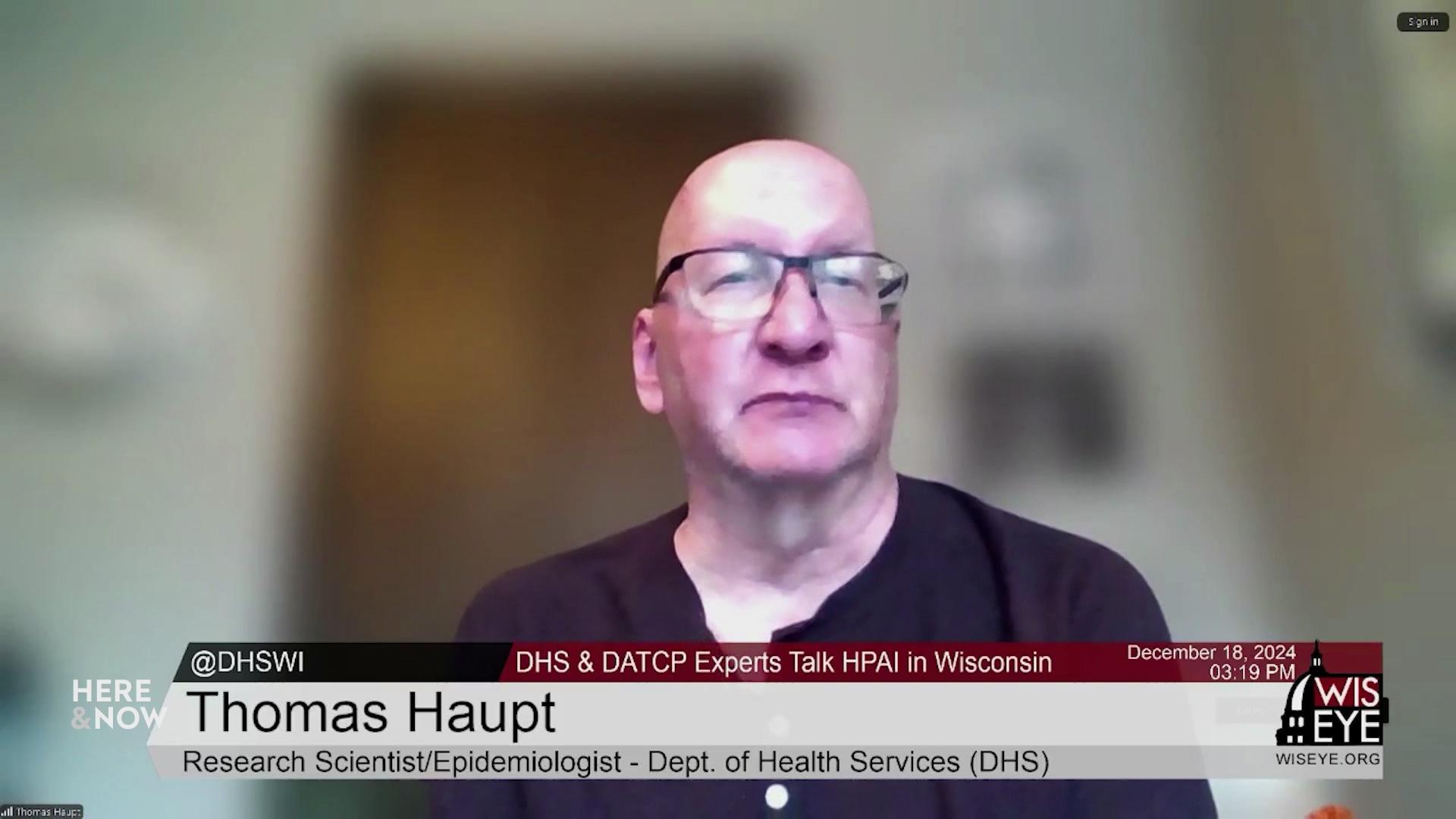 A still image from a video shows Thomas Haupt seated in front of a blurred background with a graphic at bottom reading 'Thomas Haupt.'