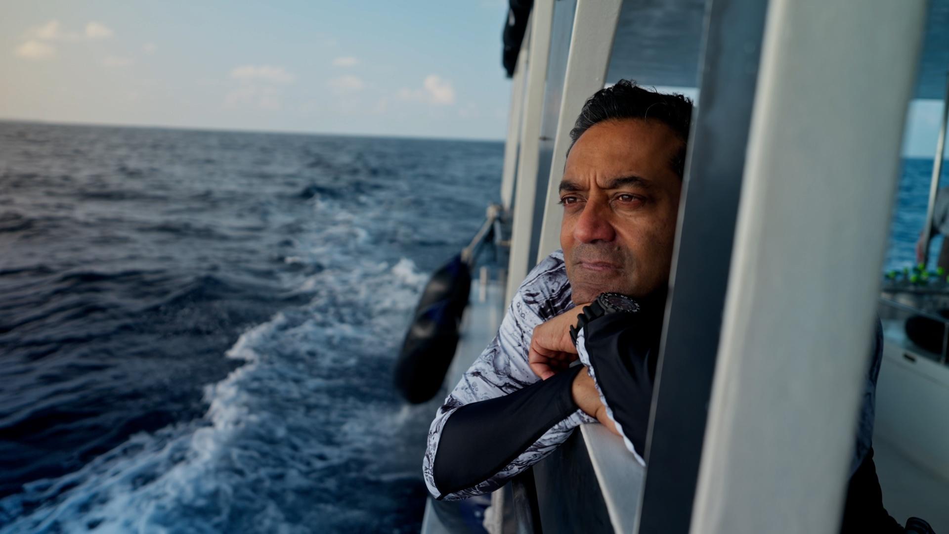 Dr. M Sanjayan leaning out of a boat window.