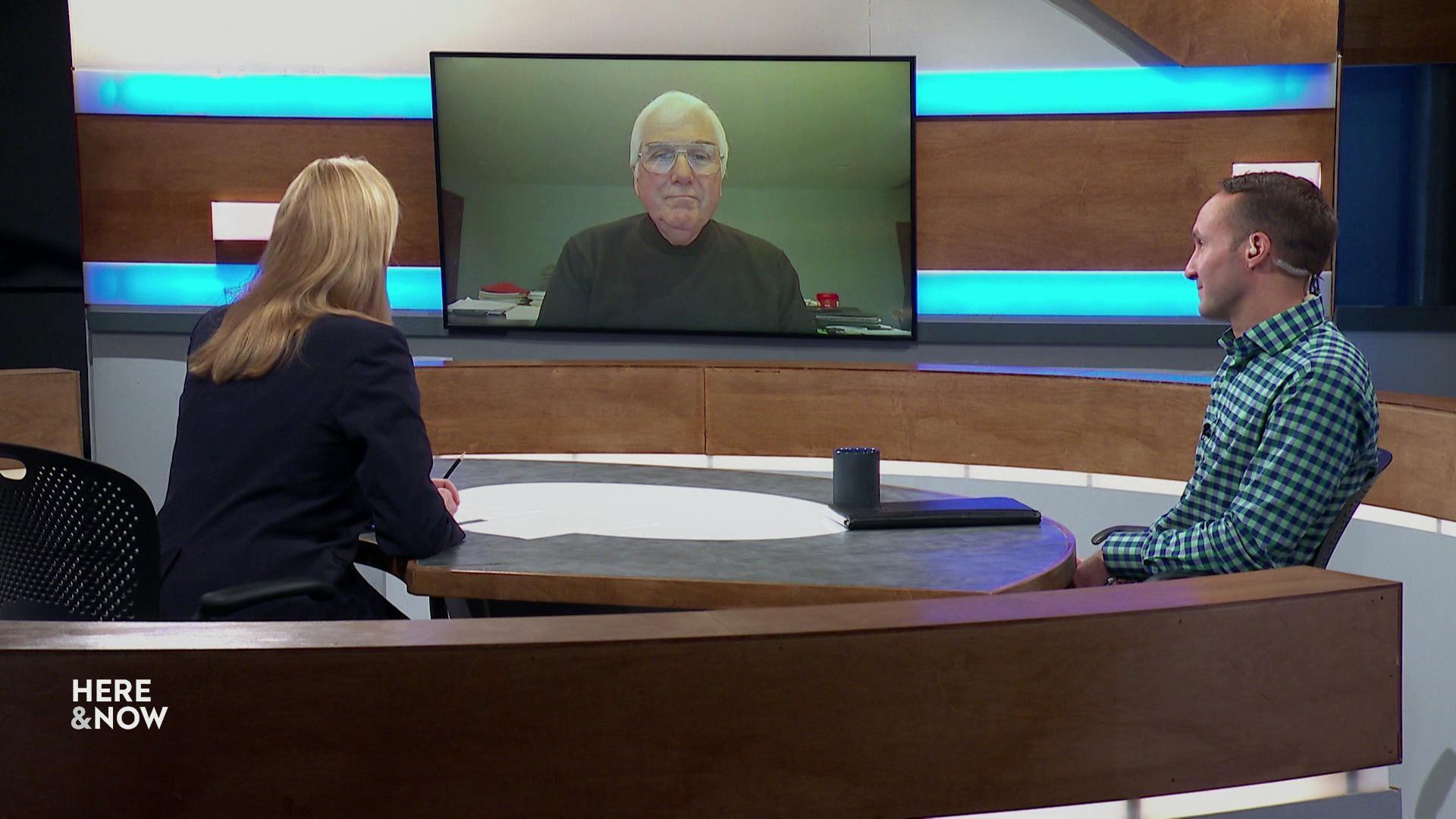 A still image shows Kevin McDonell seated at the 'Here & Now' set featuring wood paneling, with a graphic at bottom reading 'Kevin McDonell' and 'Lincoln Avenue Communities'
