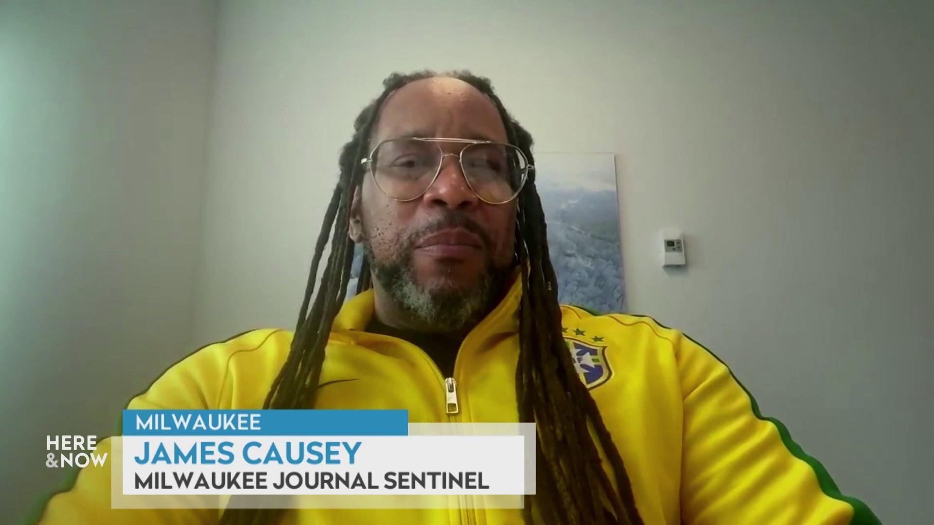 A still image shows James Causey seated in front of a picture of the ocean, with a graphic at the bottom that reads 'Milwaukee,' 'James Causey' and 'Milwaukee Journal Sentinel.'