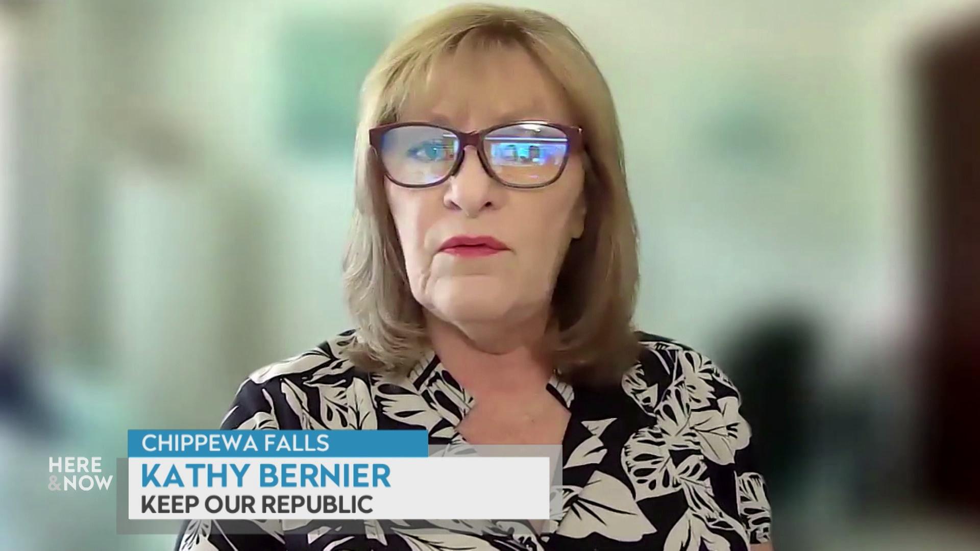 A still image from a video shows Kathy Bernier seated with a blurred out screen behind her with a graphic at bottom reading 'Chippewa Falls,' 'Kathy Bernier' and 'Keep Our Republic.'