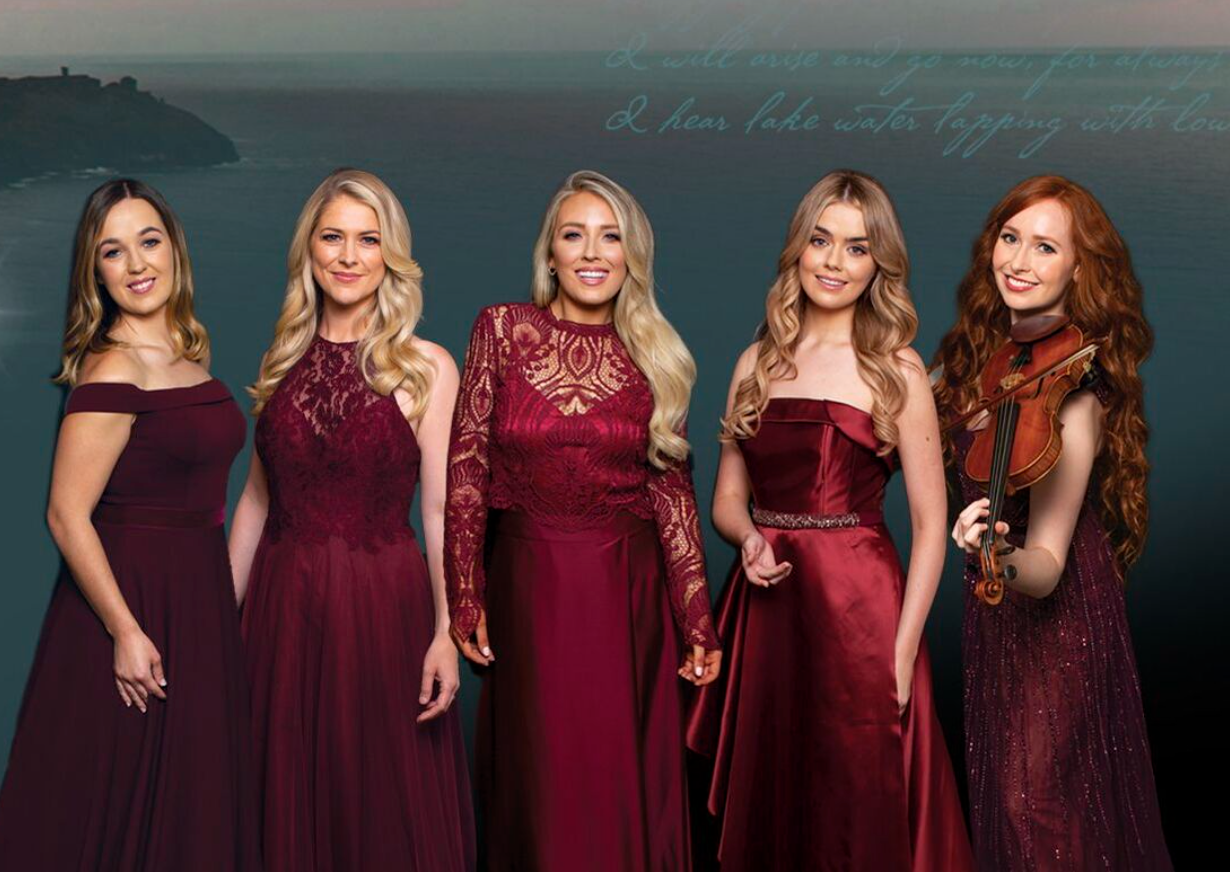 the singers of celtic woman in red dresses