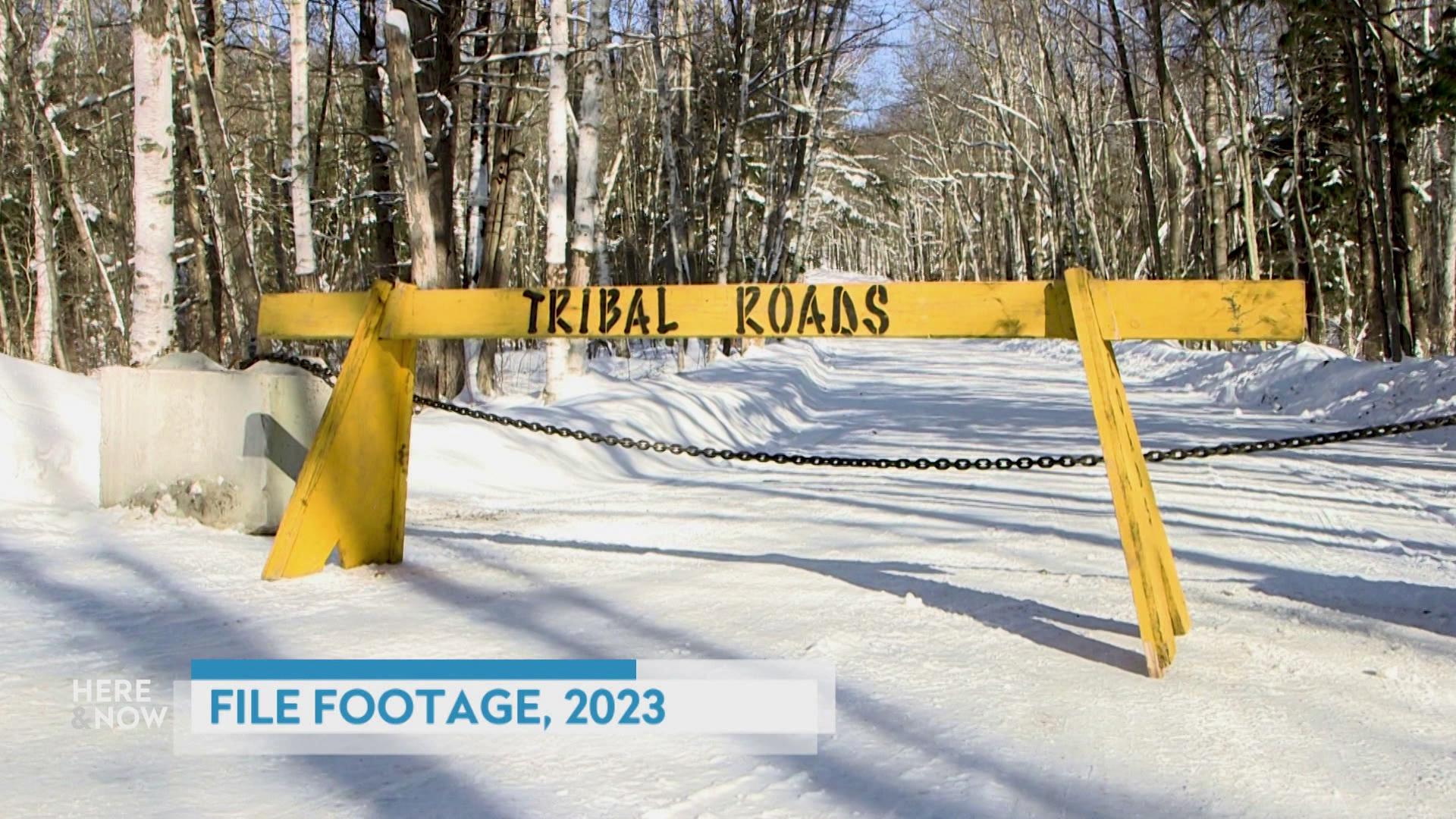 A still image from a video shows a snow covered street with a yellow barricade reading 'Tribal Roads' with a graphic at bottom reading 'File Footage, 2023.'