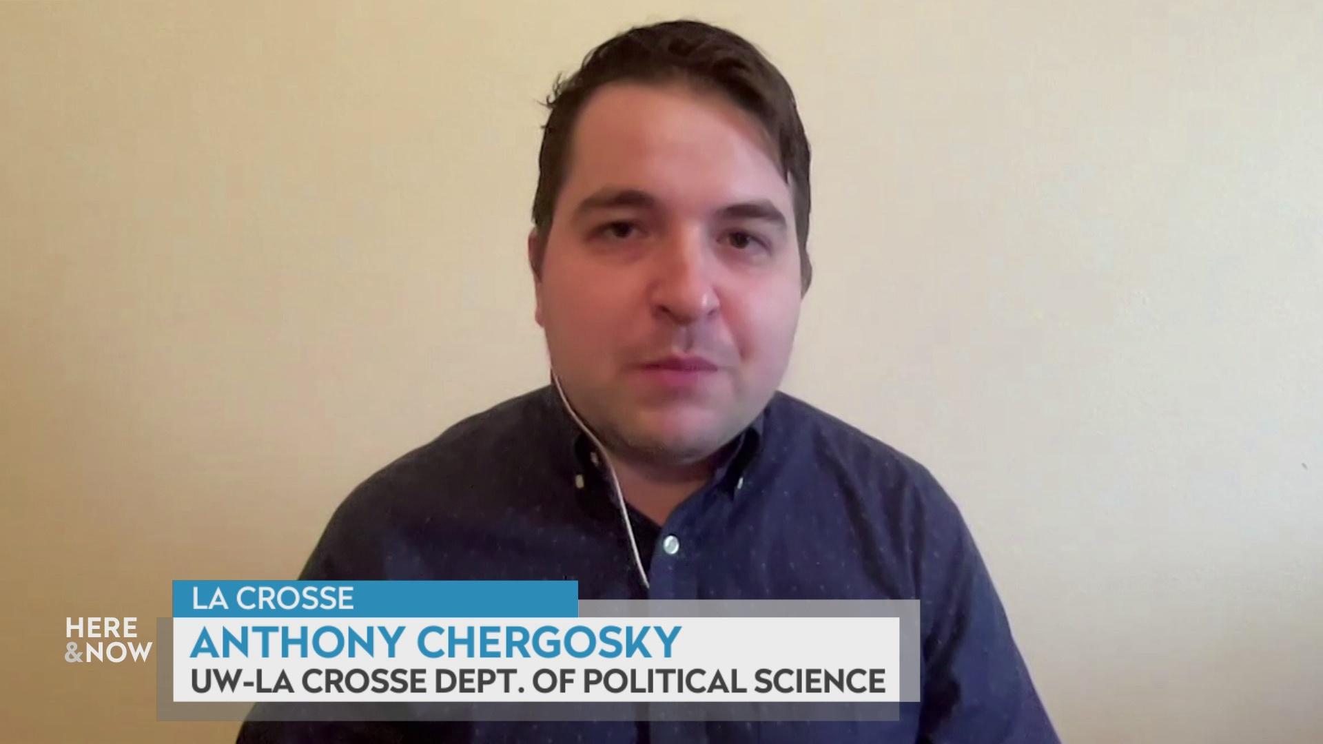 A still image from a video shows Anthony Chergosky seated in front of a blank wall, with a graphic at bottom reading 'La Crosse,' 'Anthony Chergosky' and 'UW-La Crosse Dept. of Political Science.'