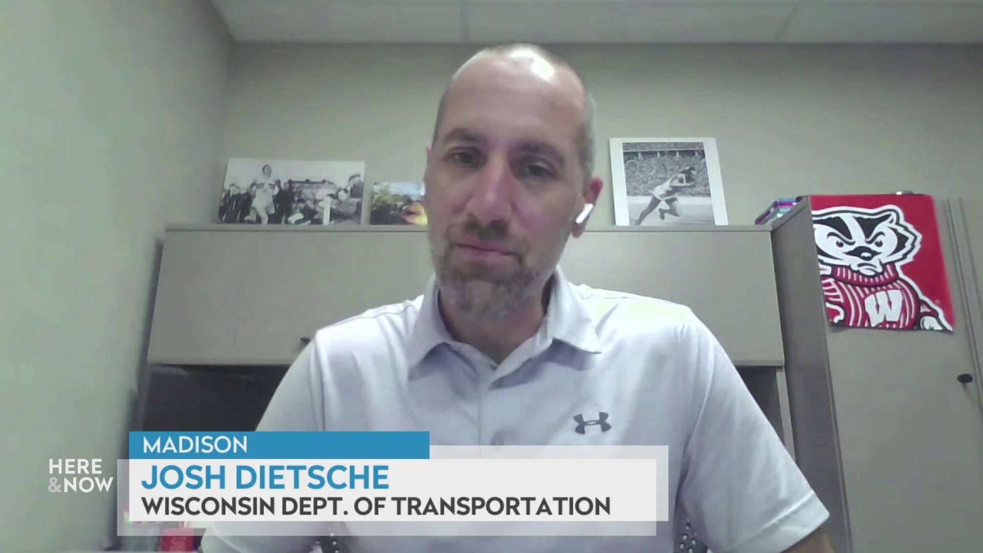 A still image shows Josh Dietsche seated in front of a shelf with various black and white sports photos, with a graphic at the bottom that reads 'Madison,' 'Josh Dietsche' and 'Wisconsin Dept. of Transportation.'