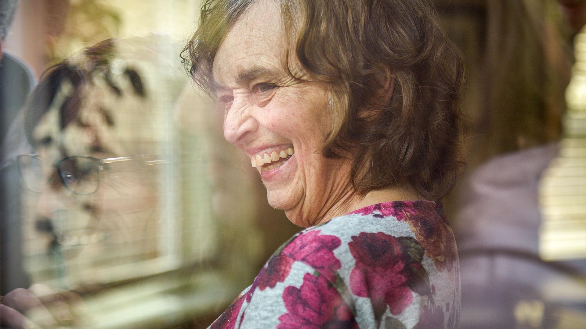 Sherry Boswell reflected in glass visiting her mother