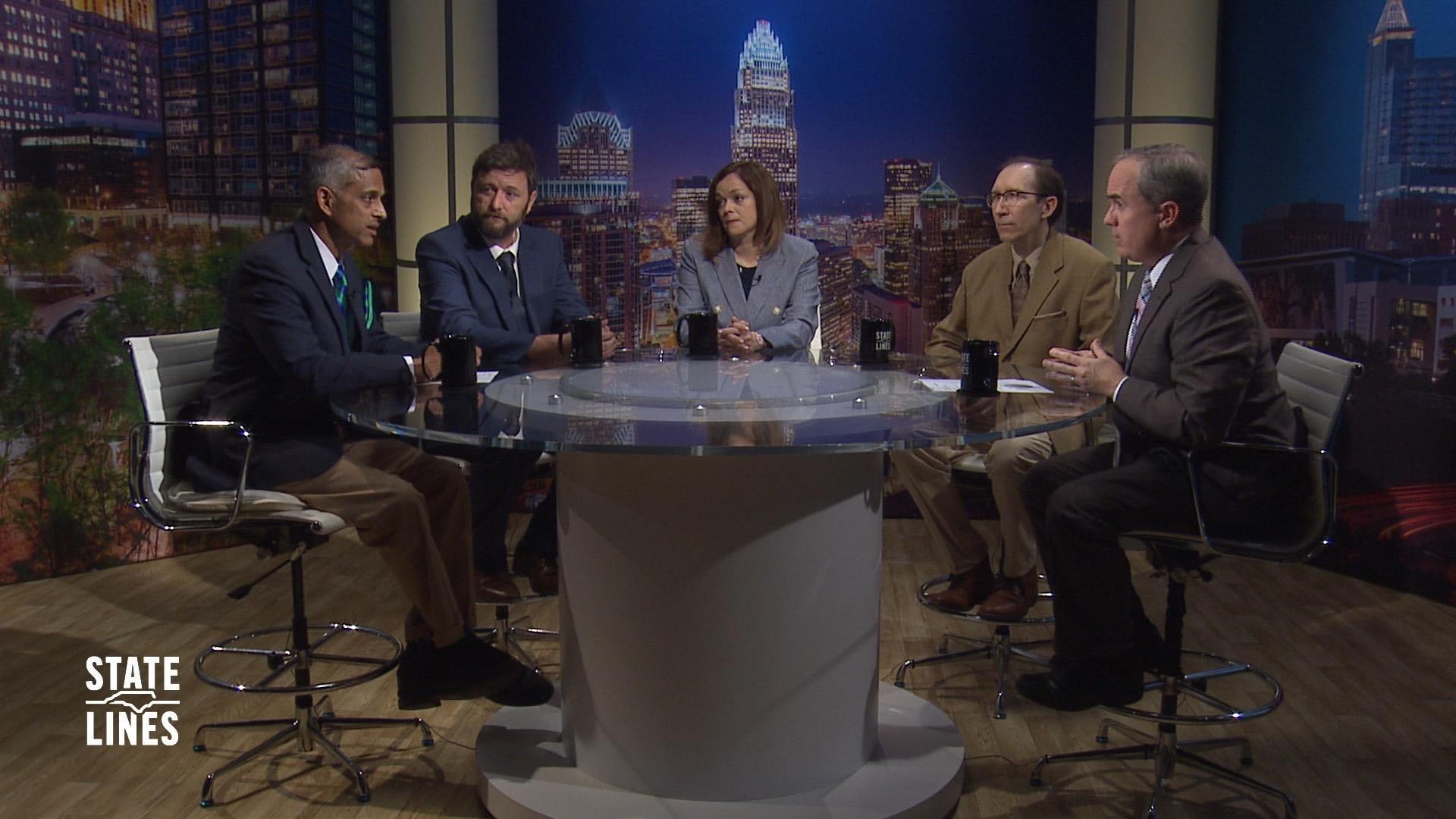 State Lines host Kelly McCullen and panelists sit at a round table on the set of State Lines