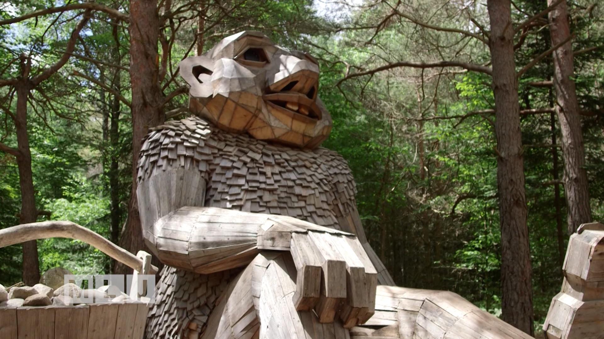 Troll sculpture in the woods.