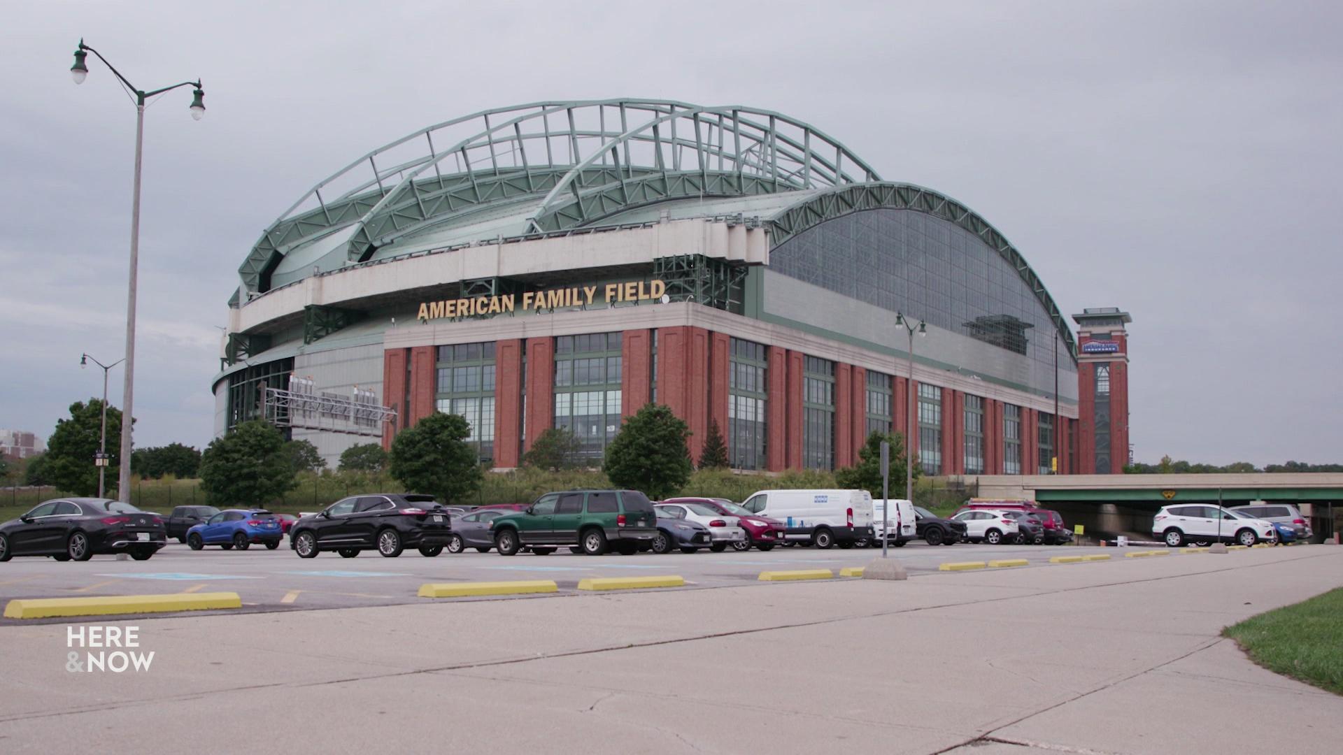 A wide shot shows the 'American Family Field' stadium from a street view.