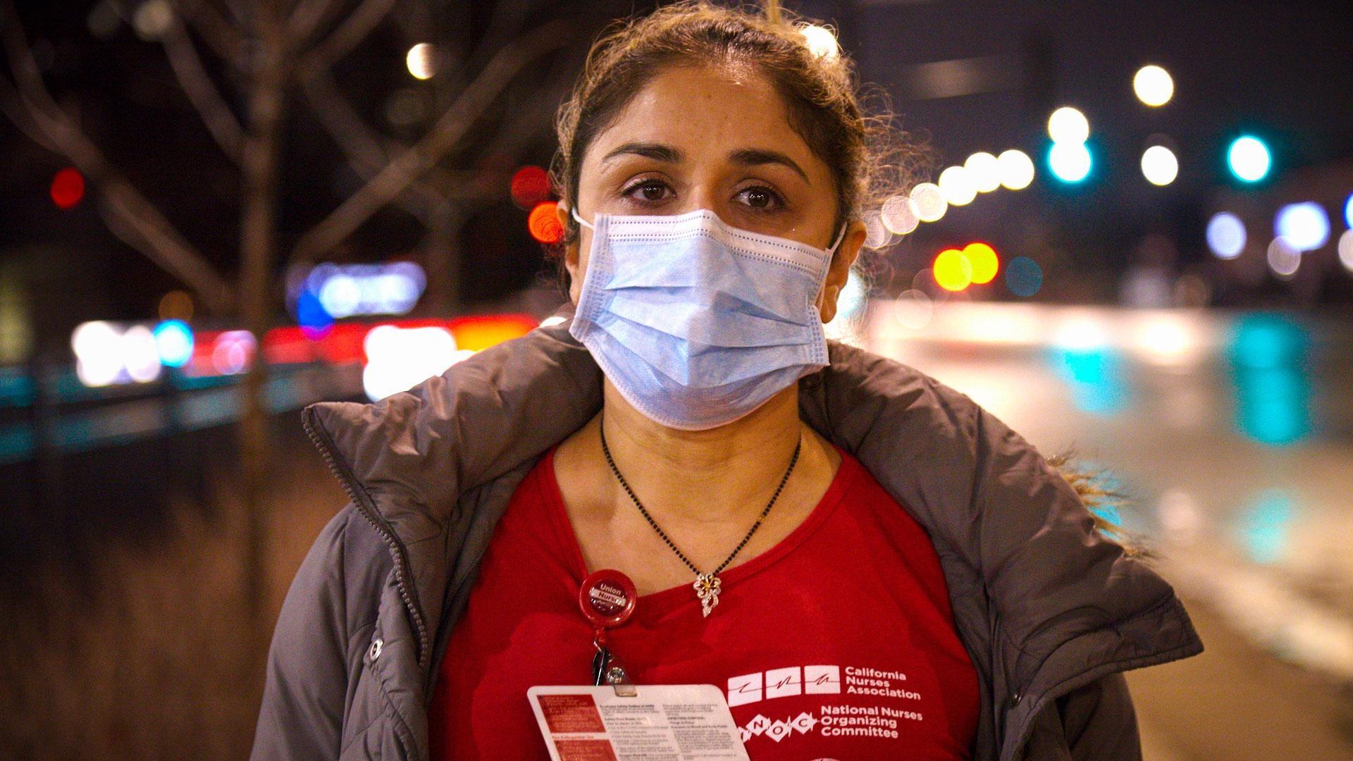 Nurse Falguni Dave on street at night with protective mask on