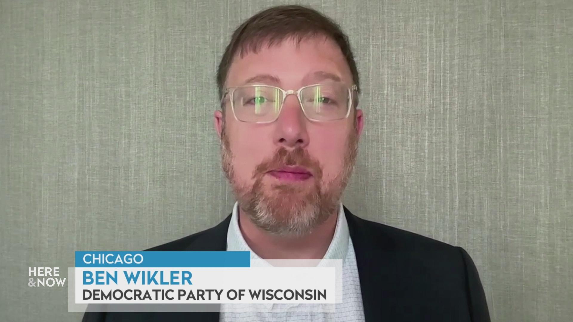 A still image from a video shows Ben Wikler seated in front of a textured background with a graphic at bottom reading 'Chicago,' 'Ben Wikler' and 'Democratic Party of Wisconsin.'