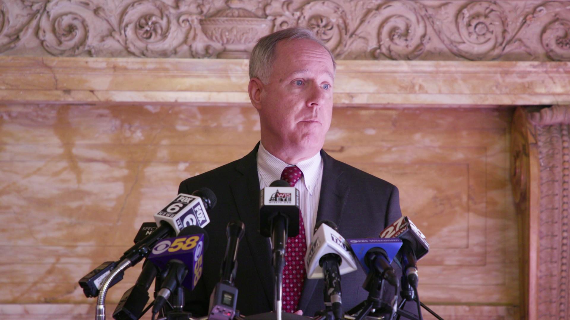 Robin Vos stands at a podium and addresses reporters